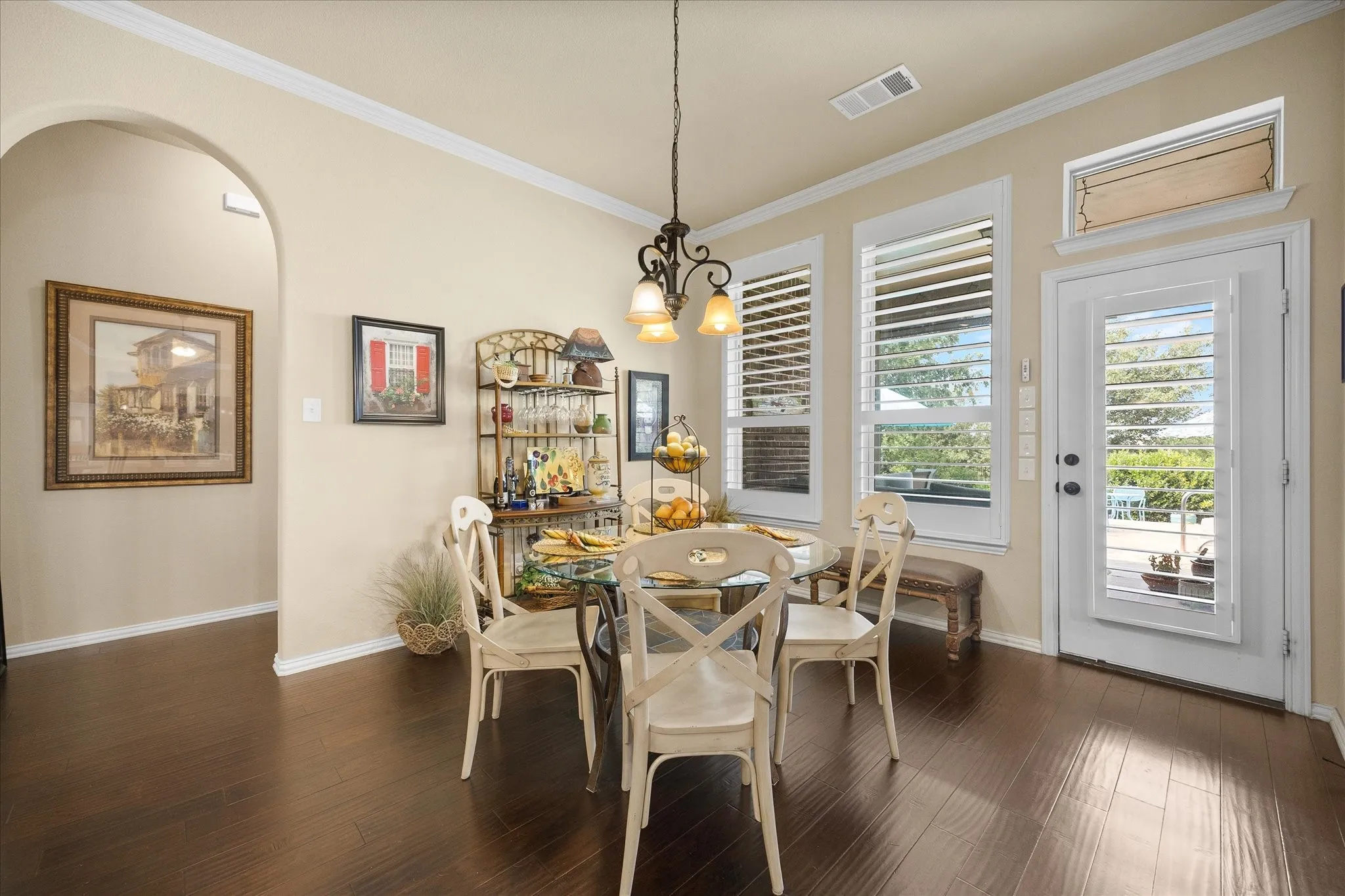 Breakfast area opens onto outdoor living area overlooking pool and koi pond.