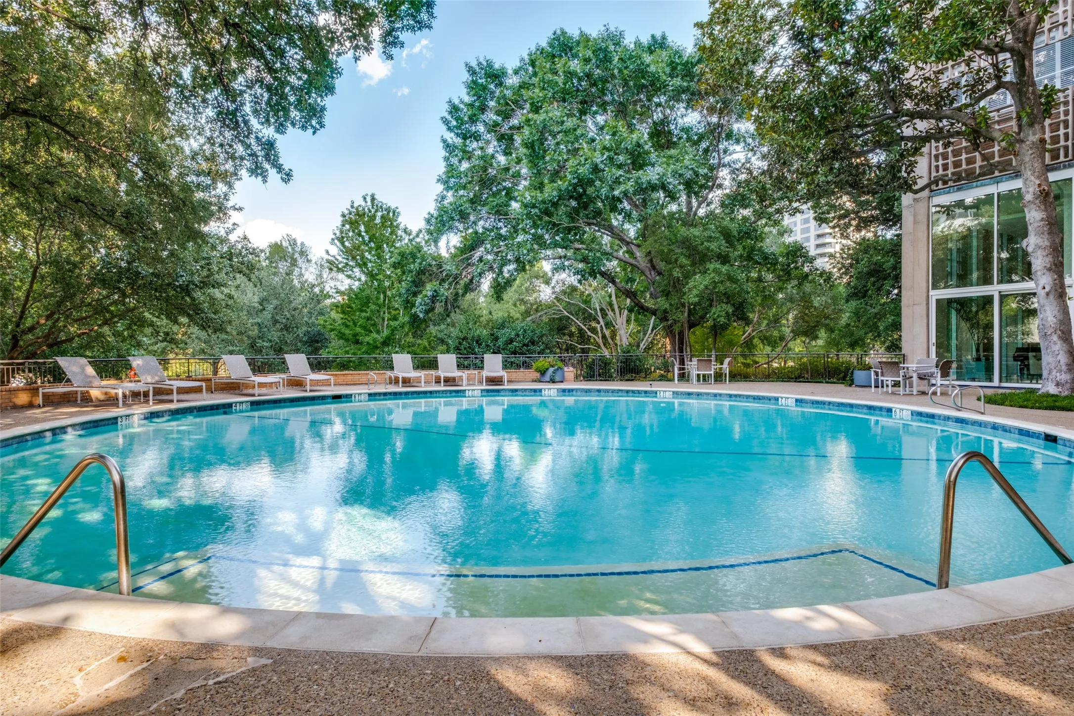 The round, very Palm Springs-like pool with chaise lounges, a gas grill, and tables and chairs for dining al fresco.