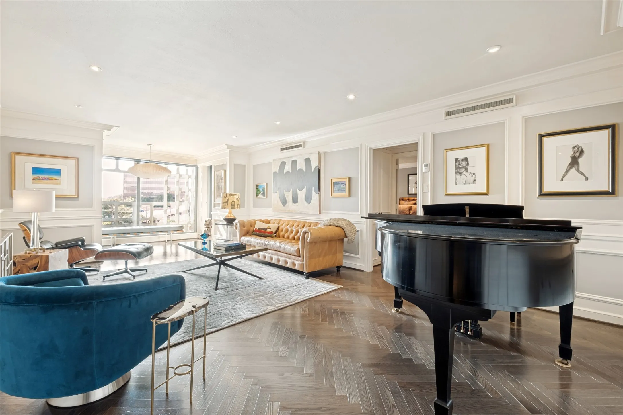 This shot of the living room shows off the beautiful wood flooring and picture framing wall details.