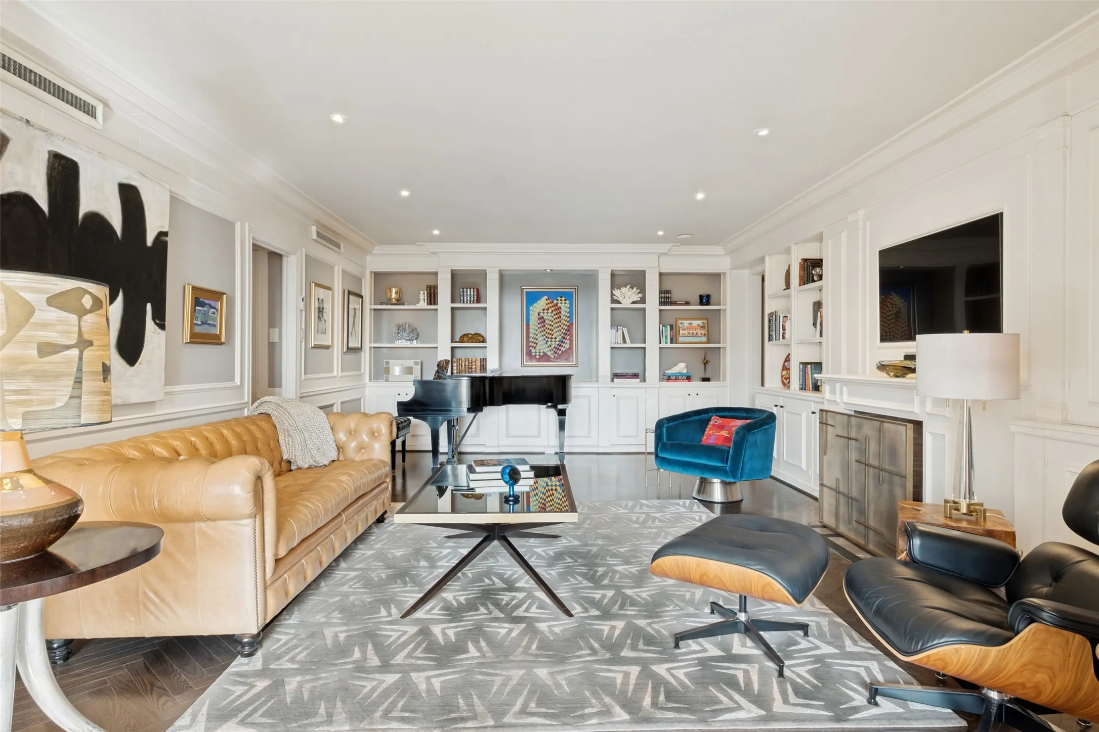 Custom bookshelves and cabinets create an ambiance as well as provide generous storage.