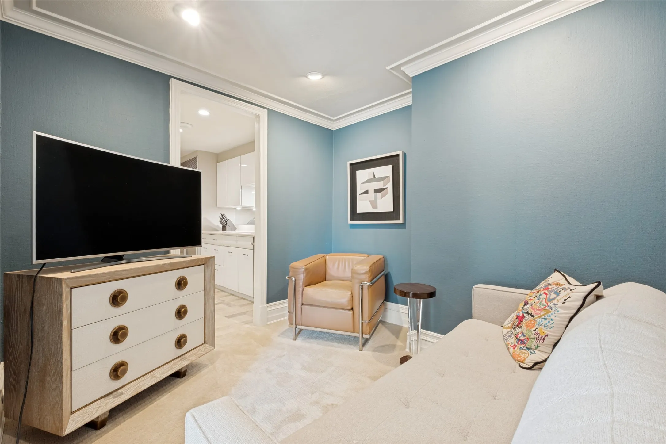 The den is nestled directly behind the kitchen and is a cozy spot to read, watch TV, or just have some quiet time.