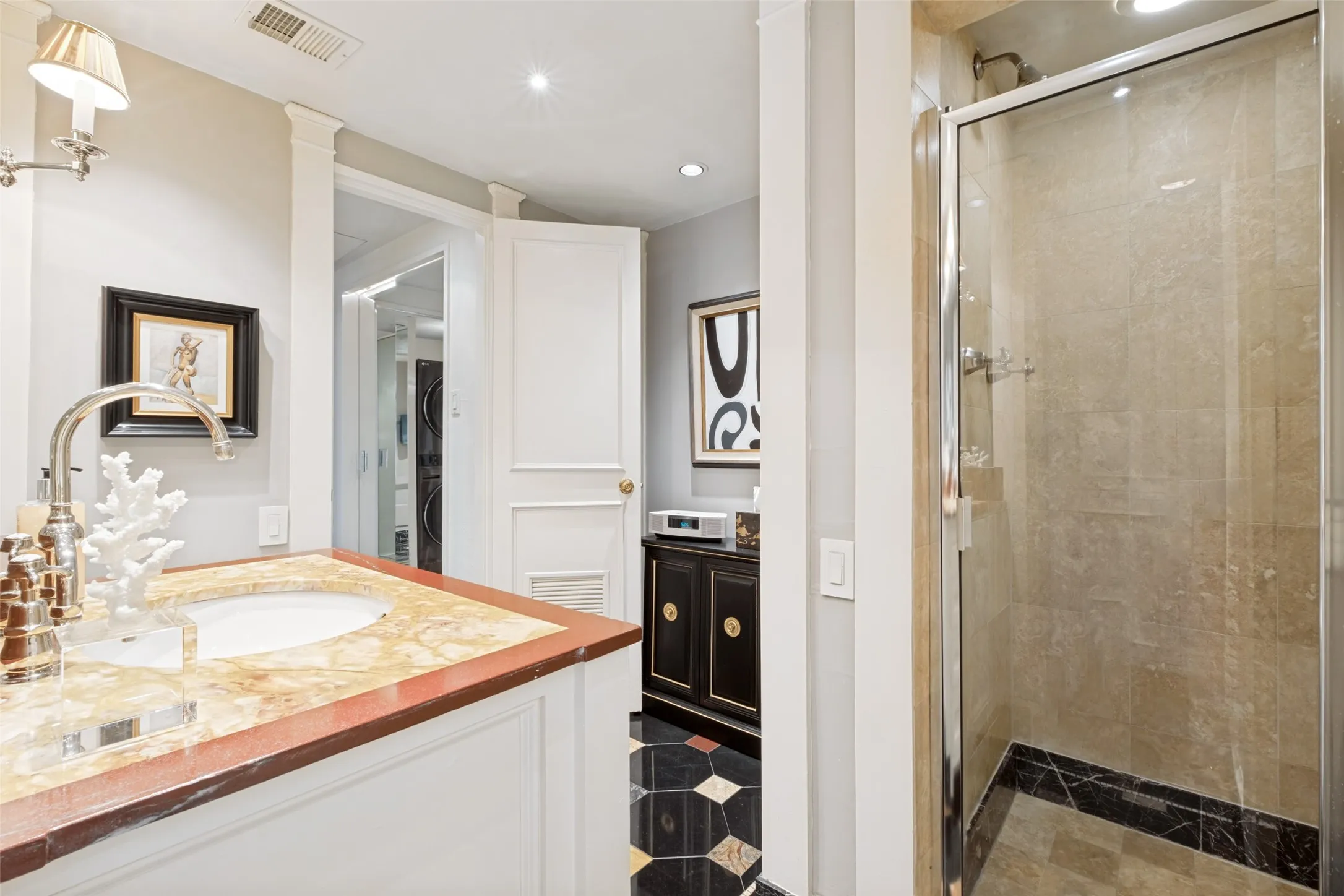 Another view of the bathroom, with the shower. There are also cabinets to the left of the shower.