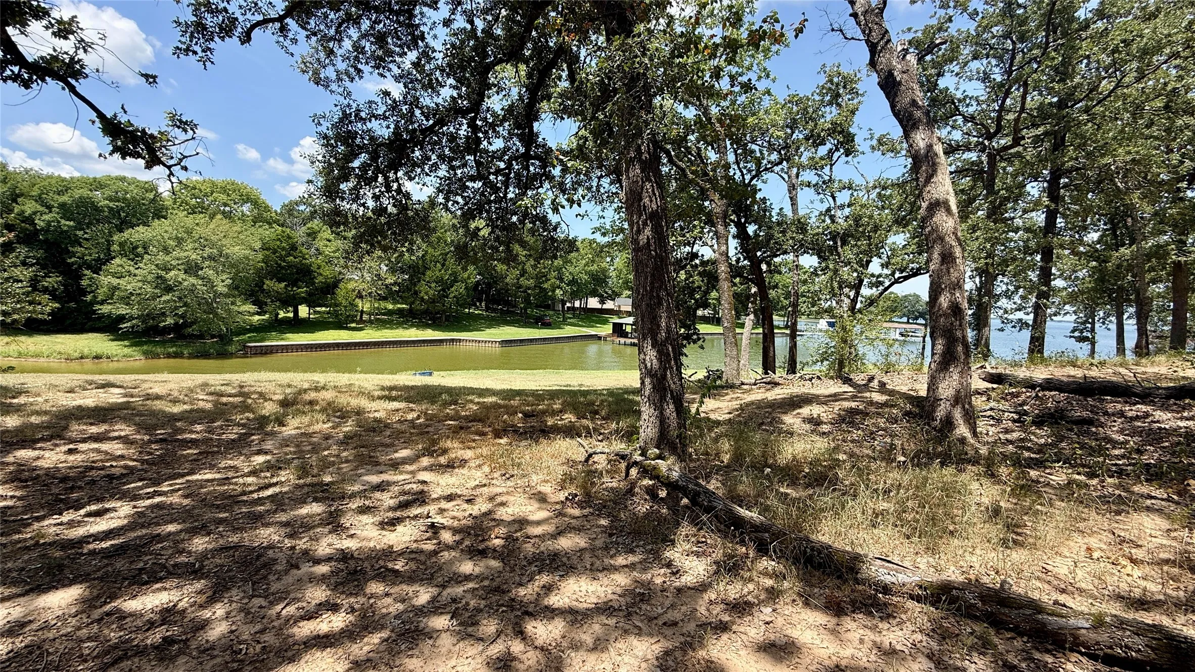 Mature trees frame another potential building area with convenient access to the waterfront and lake views.