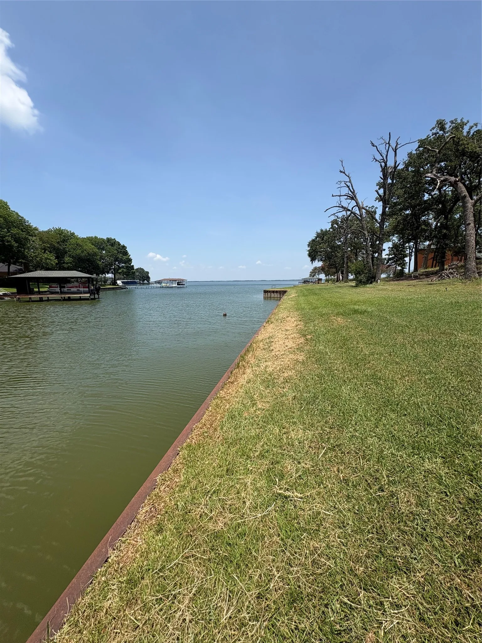 Peaceful waterfront setting in Southside Shores with a steel retaining wall and views toward the open waters of Richland Chambers Lake.