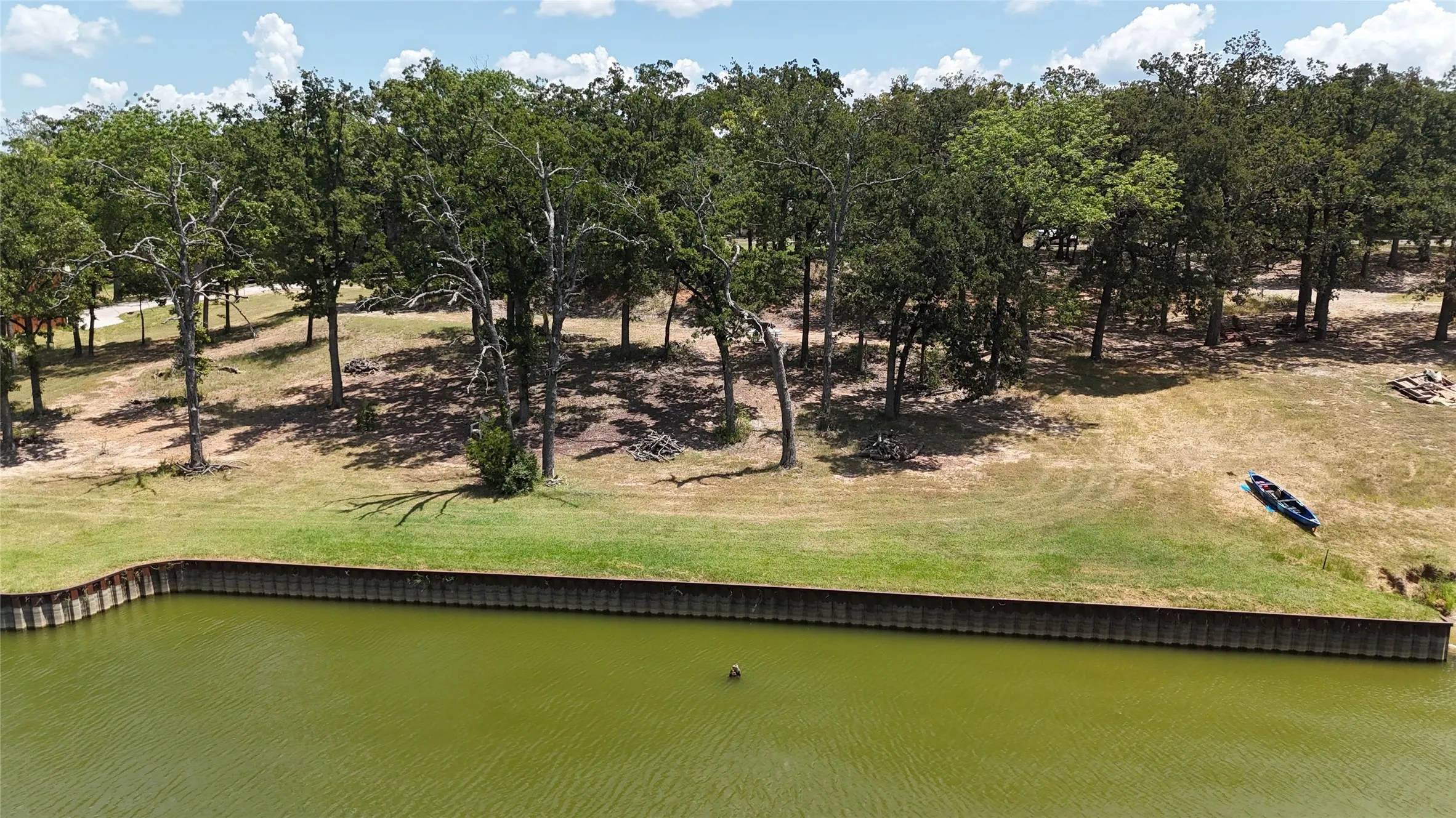View from the water highlights the mature trees, sloping terrain and substantial shoreline of these Southside Shores waterfront lots.