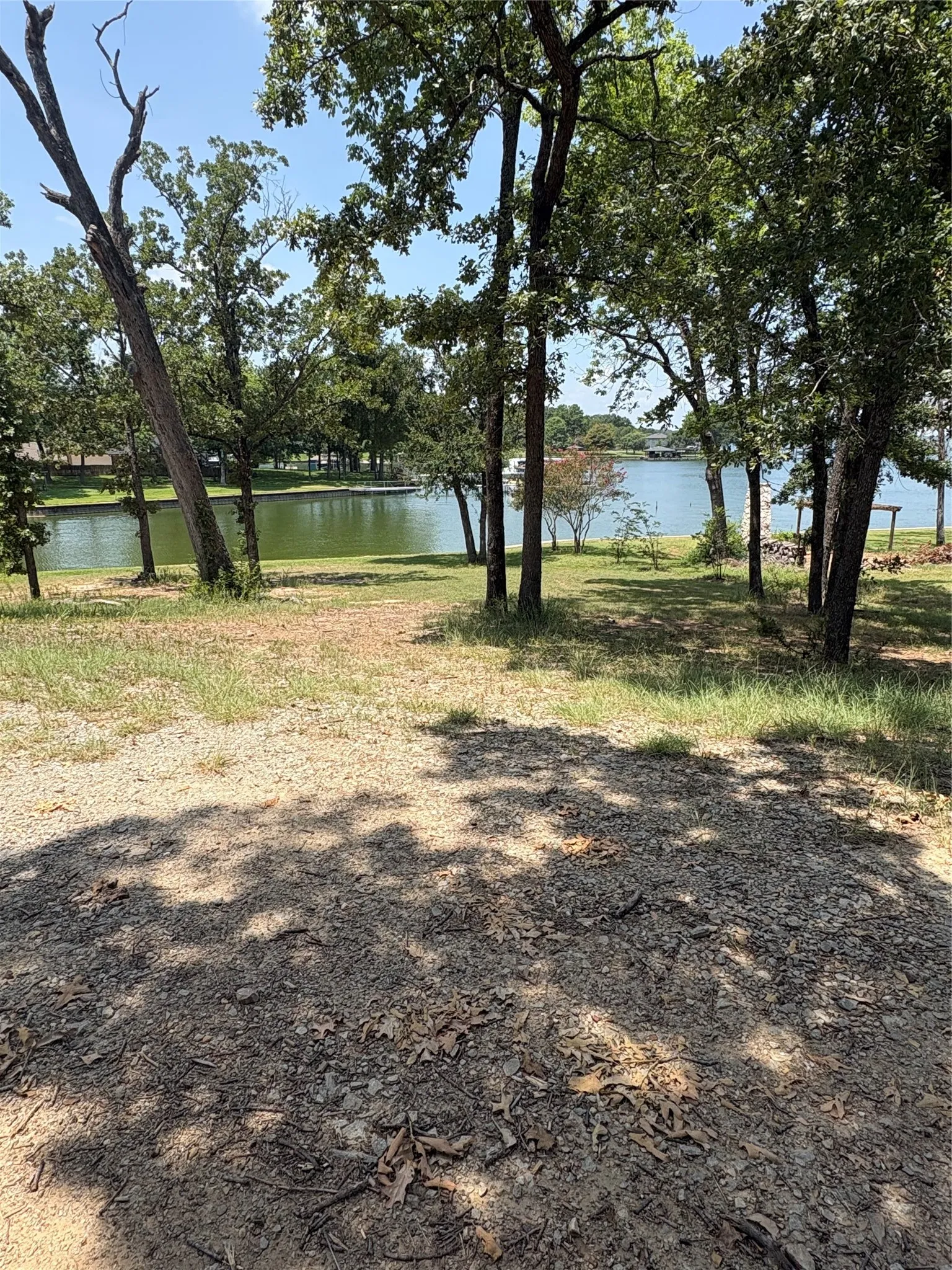Richland Chambers Lake views peek through mature shade trees from this waterfront property in Southside Shores.