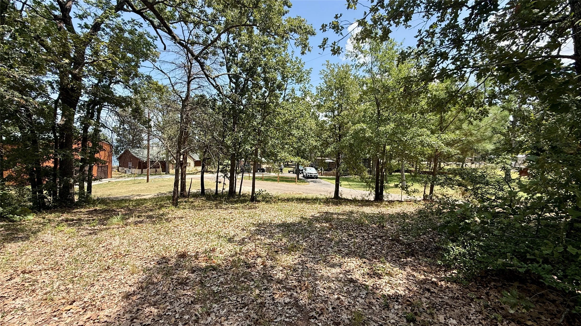 Mature trees cover portions of the property, offering natural shade and character for a future waterfront home.