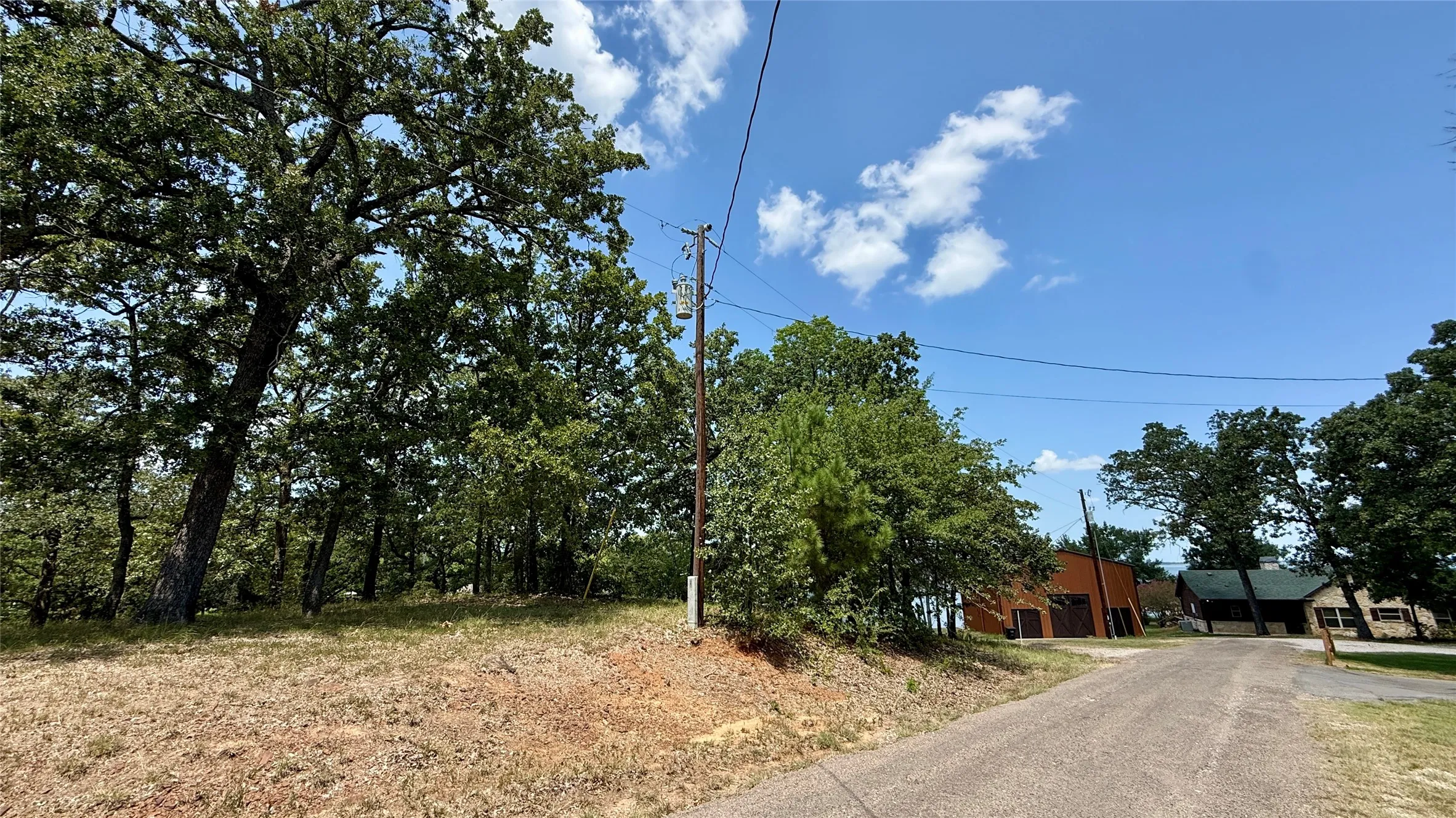 Roadside view of the wooded Cambridge Drive property in Southside Shores, a waterfront community on Richland Chambers Lake.