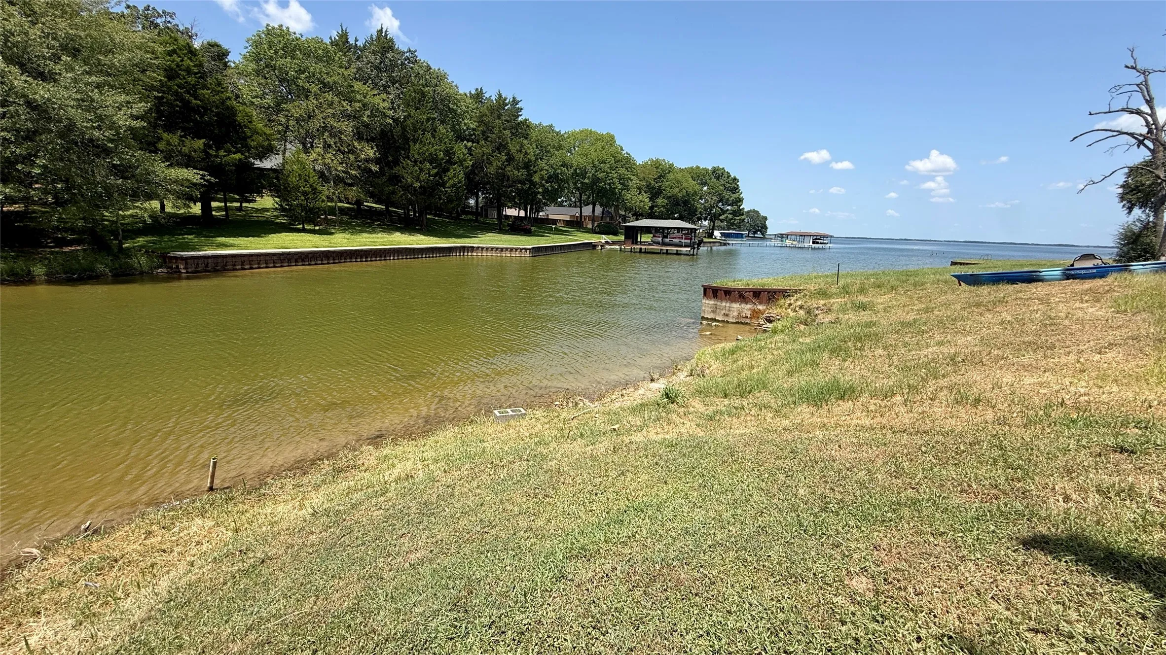 Protected waterfront provides direct lake access with open Richland Chambers Lake visible beyond the shoreline.