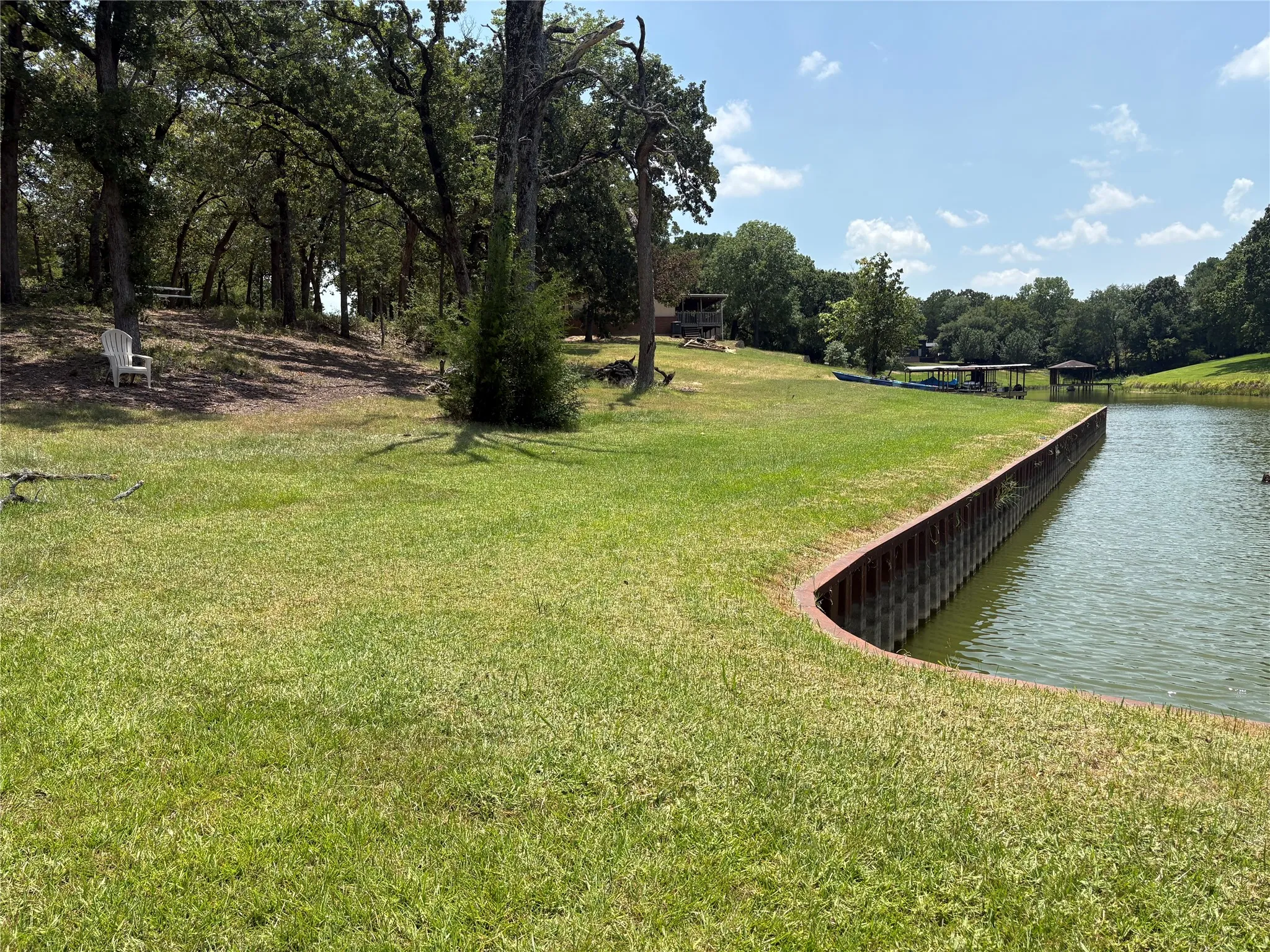 Grassy shoreline and mature trees create a beautiful natural setting for a future Richland Chambers Lake home.