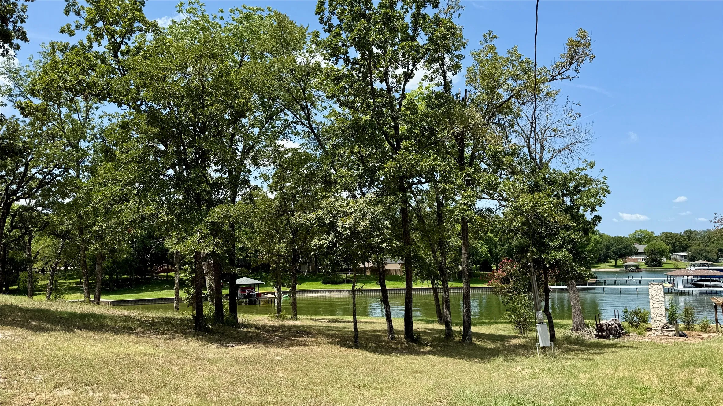 Long steel retaining wall and mature trees highlight the extensive waterfront offered by Lots 8 and 13 in Southside Shores.
