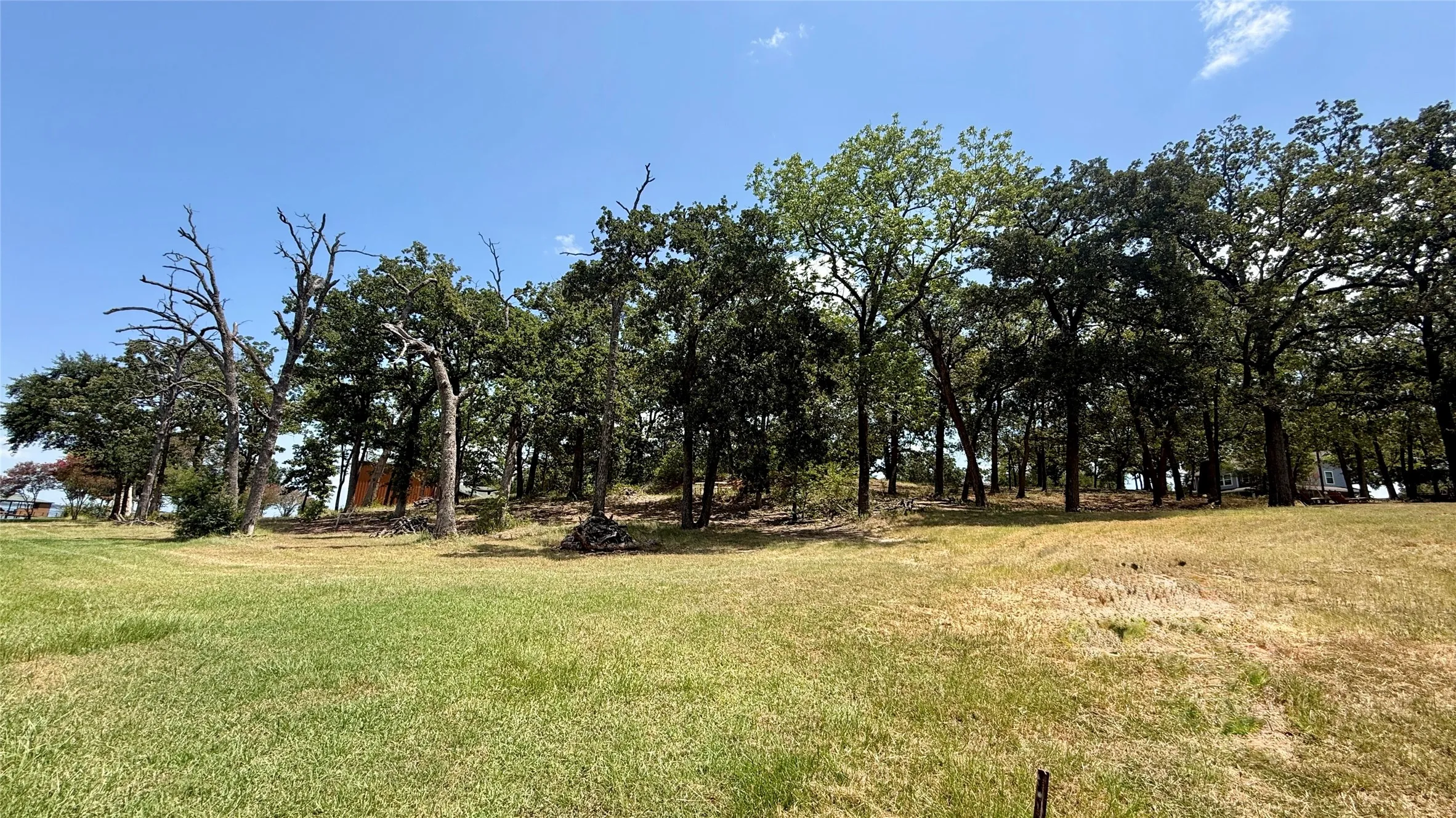 Mature trees create a shaded, peaceful setting with plenty of natural character on this Streetman waterfront property.