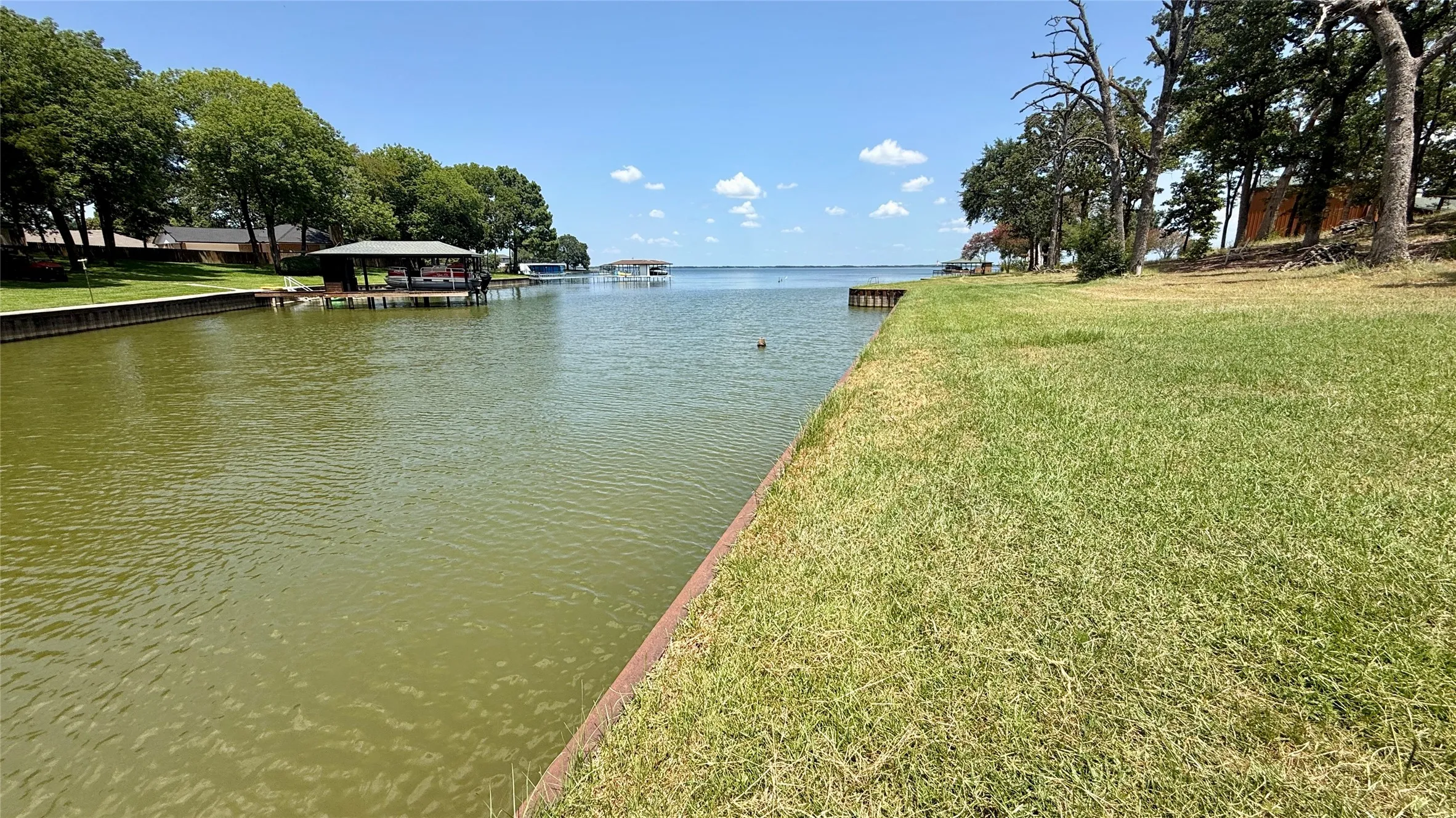 Steel retaining wall, grassy shoreline and lake access combine for an inviting Richland Chambers Lake waterfront setting.