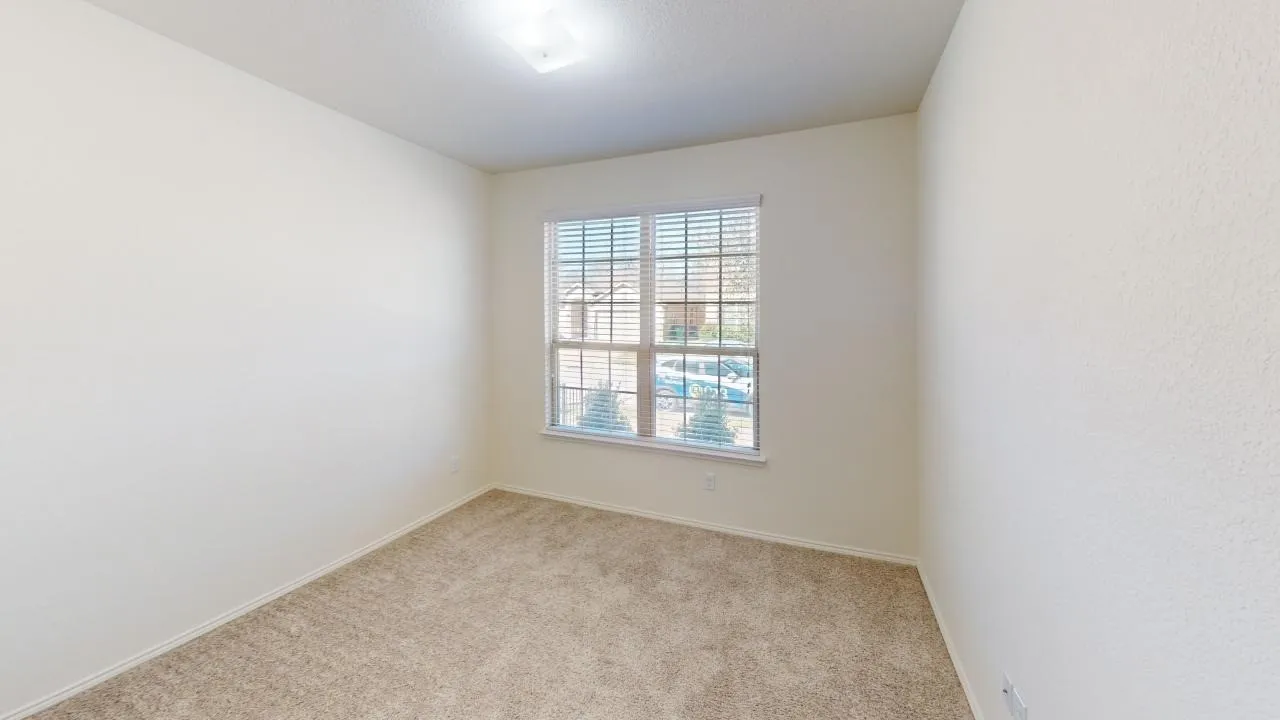 Neutral wall finishes with textured carpet flooring