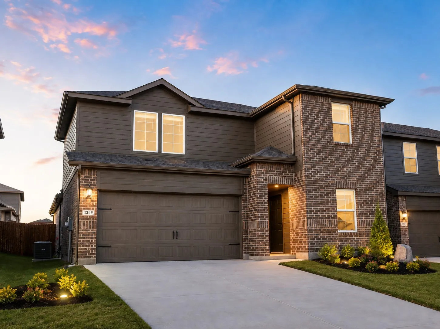 Impressive Two-Story Exterior.Beautiful modern brick-and-stone elevation featuring a welcoming covered entry, two-car garage, attractive landscaping, and excellent curb appeal.