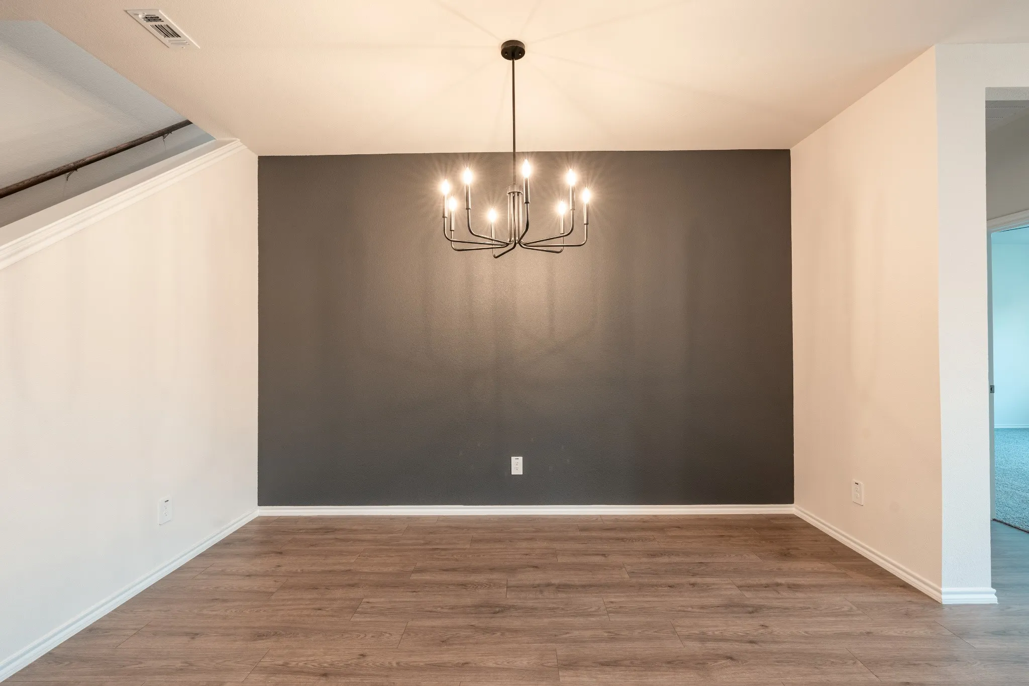 Dining Area with Custom Artist-Painted Accent Wall & Upgraded Light Fixture