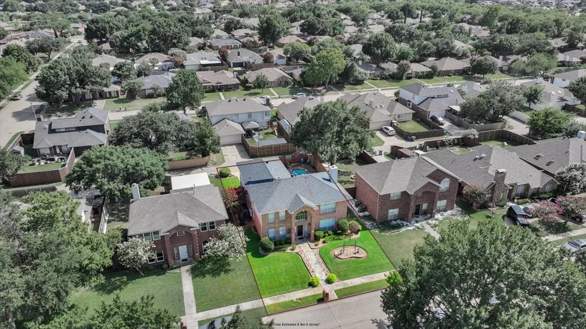 Two-story brick facade, arched entry, mature landscaping, manicured front lawn, and a private rear yard with a pool