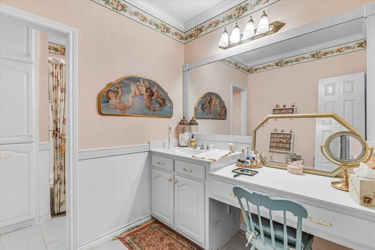 Built-in vanity with integrated storage, full-width mirror, and overhead lighting