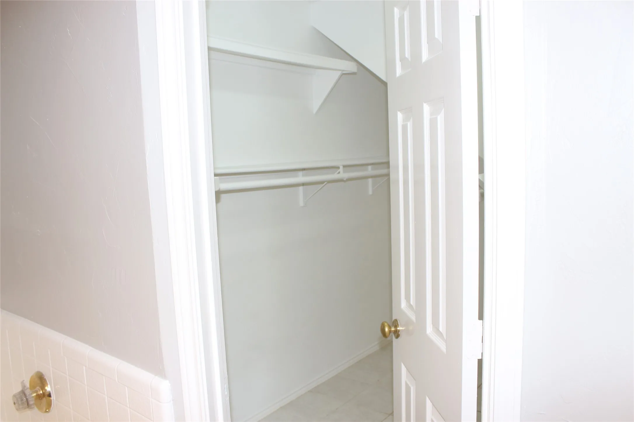Walk-in closet with integrated shelving and hanging rods