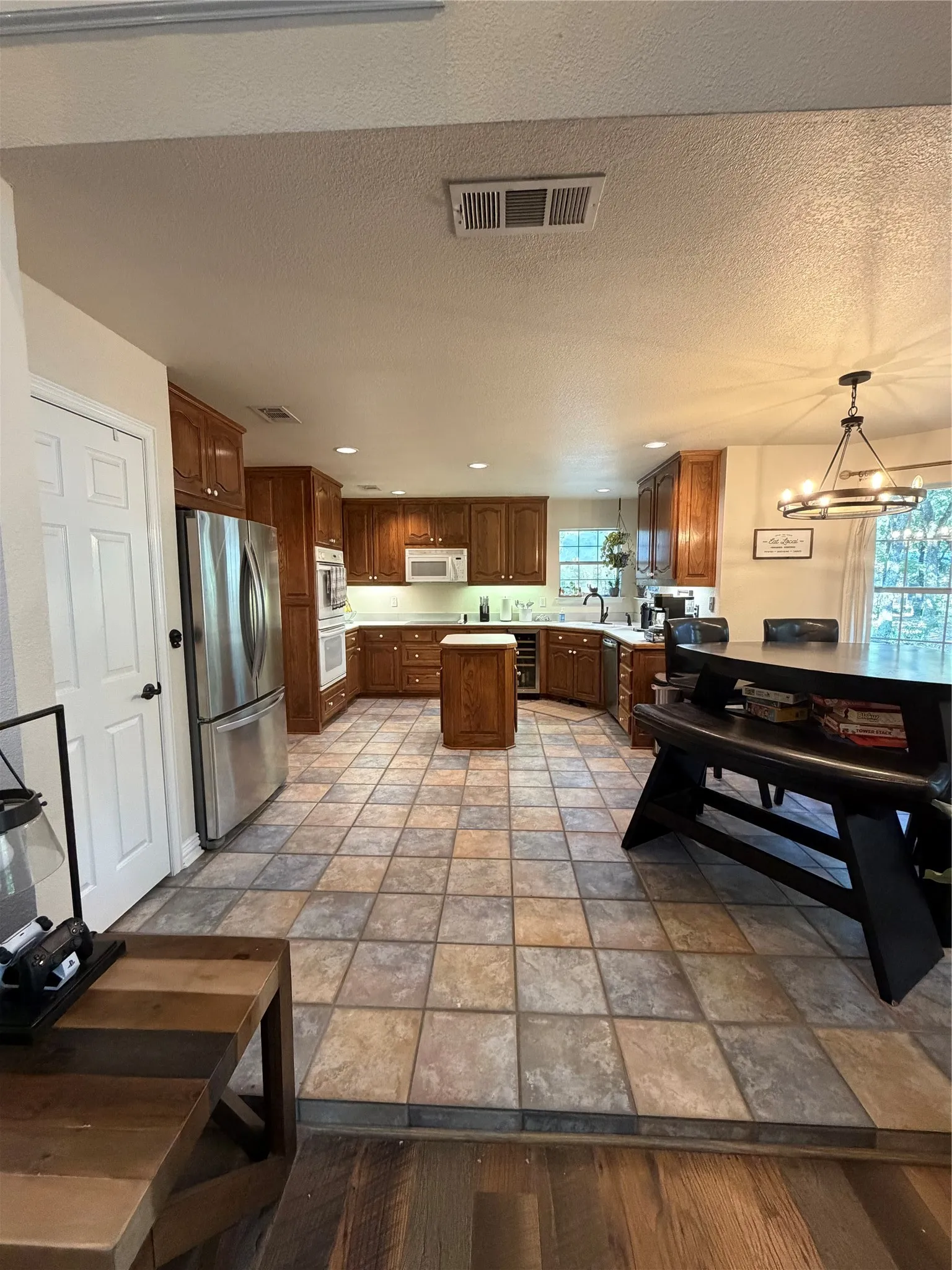 Bright, open Kitchen featuring breakfast area, kitchen island, and pantry