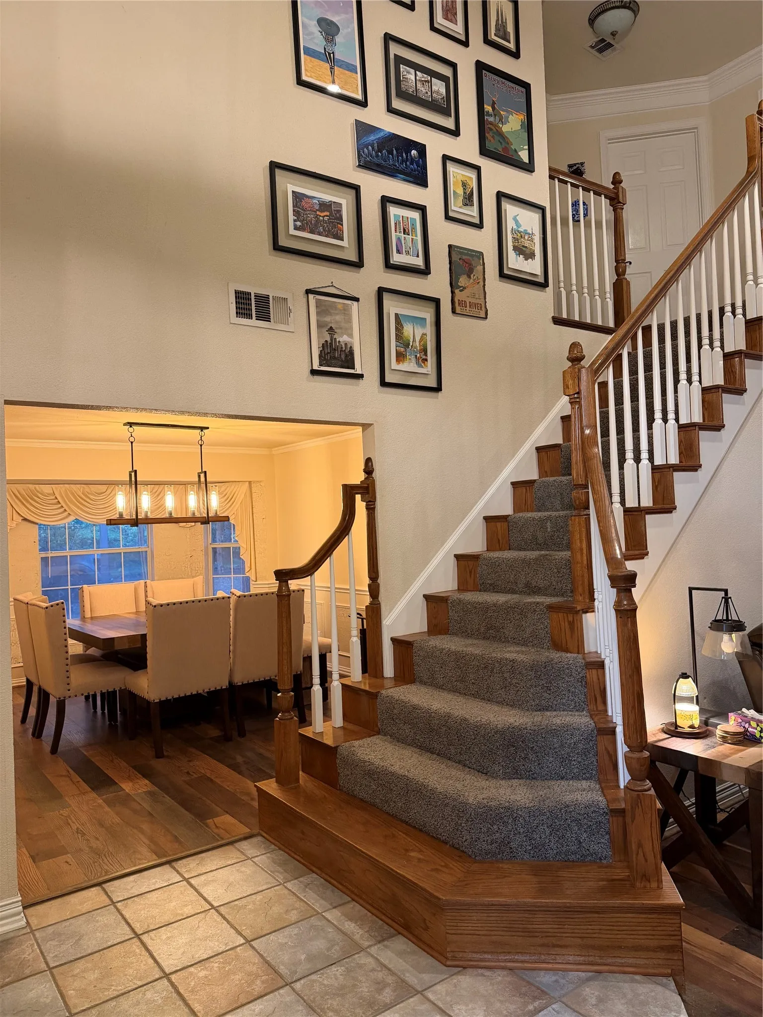 Grand staircase with wood-finish handrail and carpeted treads