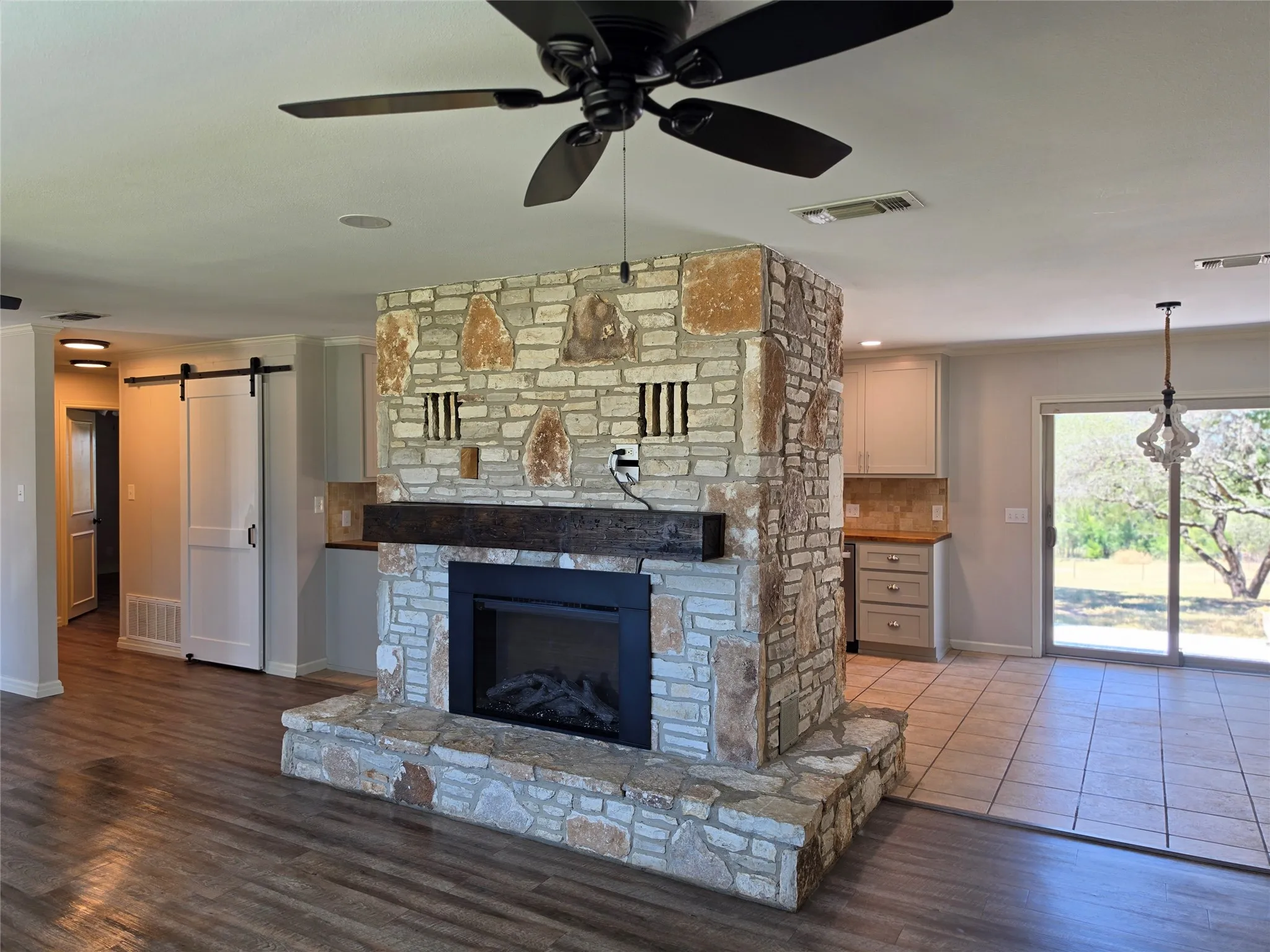 Stone-clad fireplace with a wood mantel