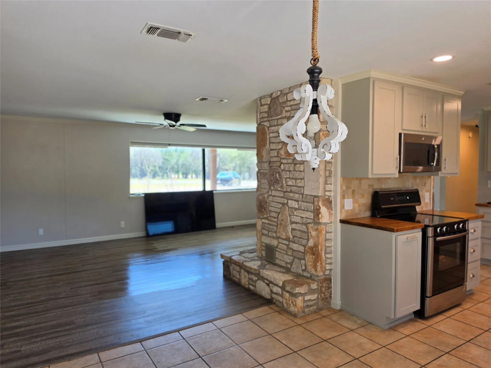 Stone-clad fireplace feature with a wood-finish mantel