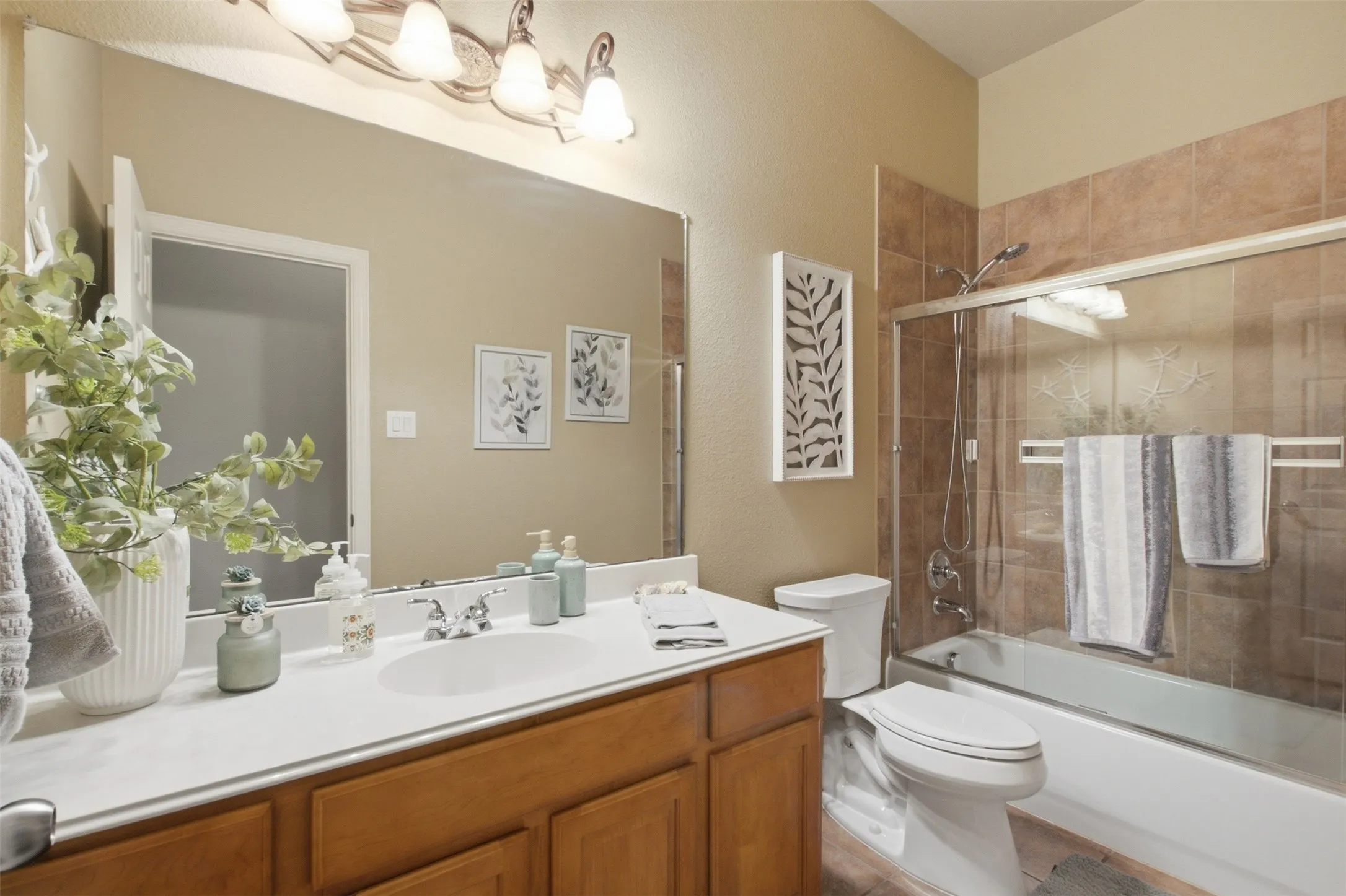 Wood-finish vanity with a white countertop and undermount sink