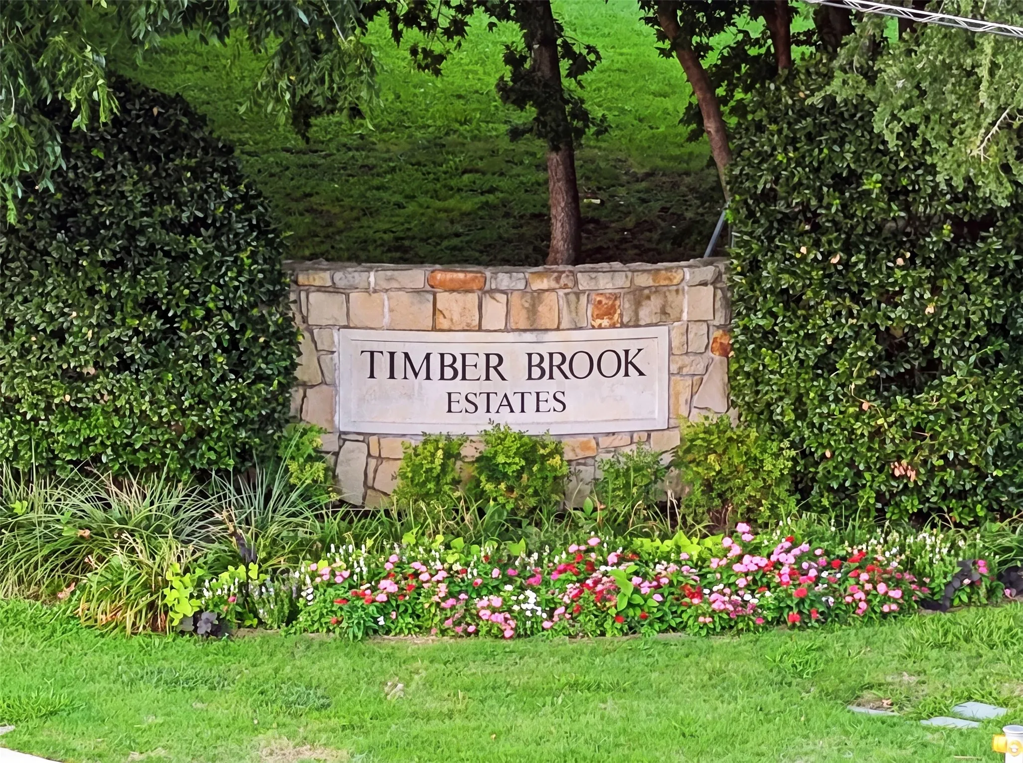 Stone-clad entryway signage with a carved plaque