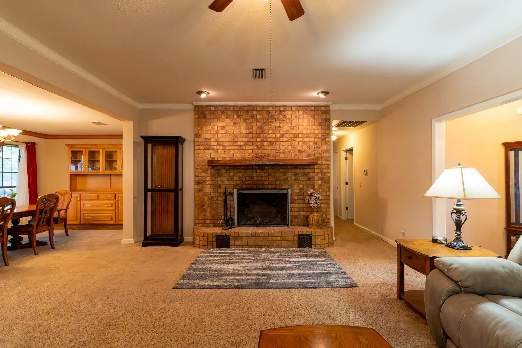 Brick fireplace with a wood mantel
