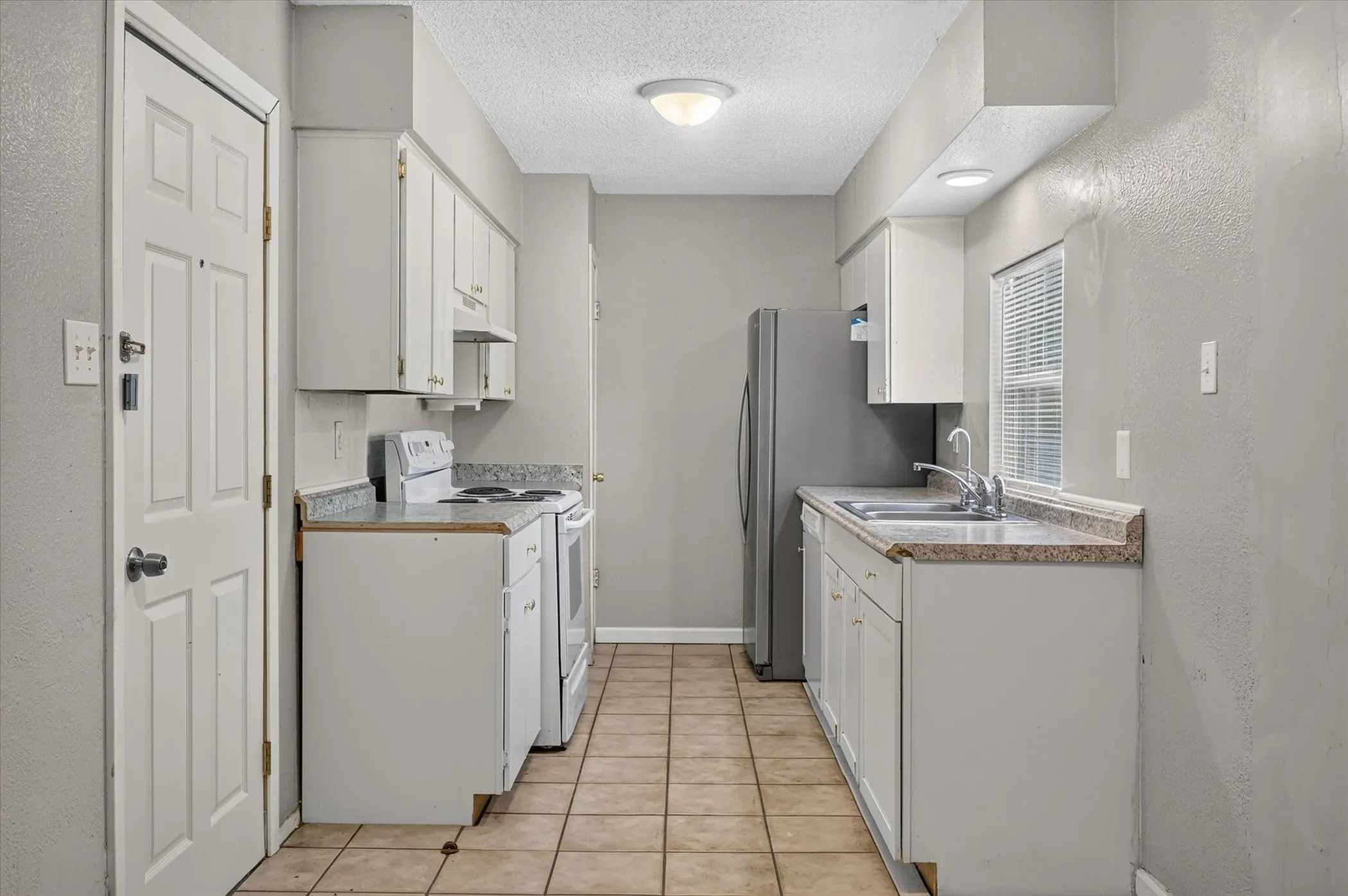 Galley kitchen with refreshed cabinetry.
