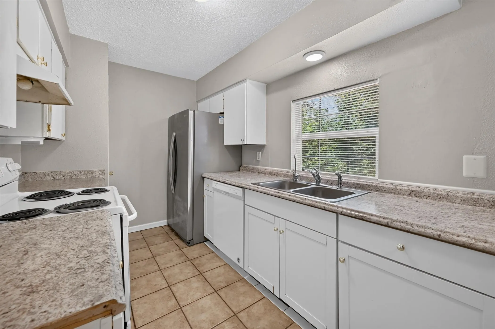 Durable laminate countertops and a backyard view from the kitchen sink make this space both functional and inviting.