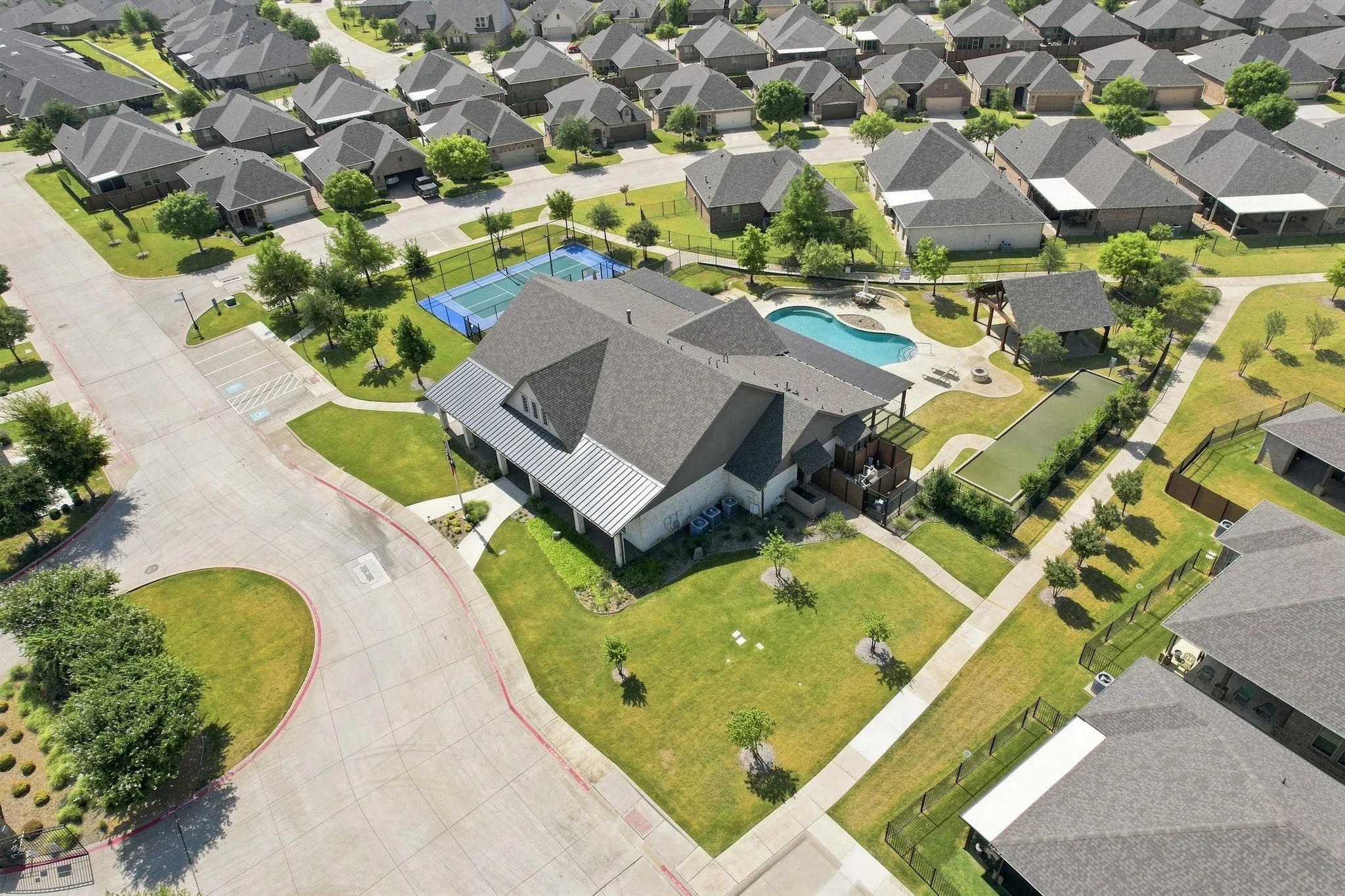 Community amenities including a swimming pool, bocce ball court, covered outdoor seating, and tennis courts