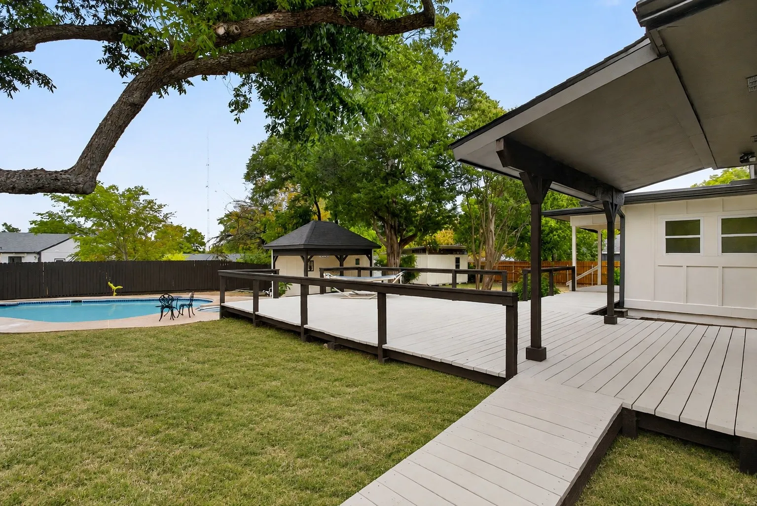 Virtually installed grass - we wanted you to see the covered area of the back porch, and all of the decked pathways.