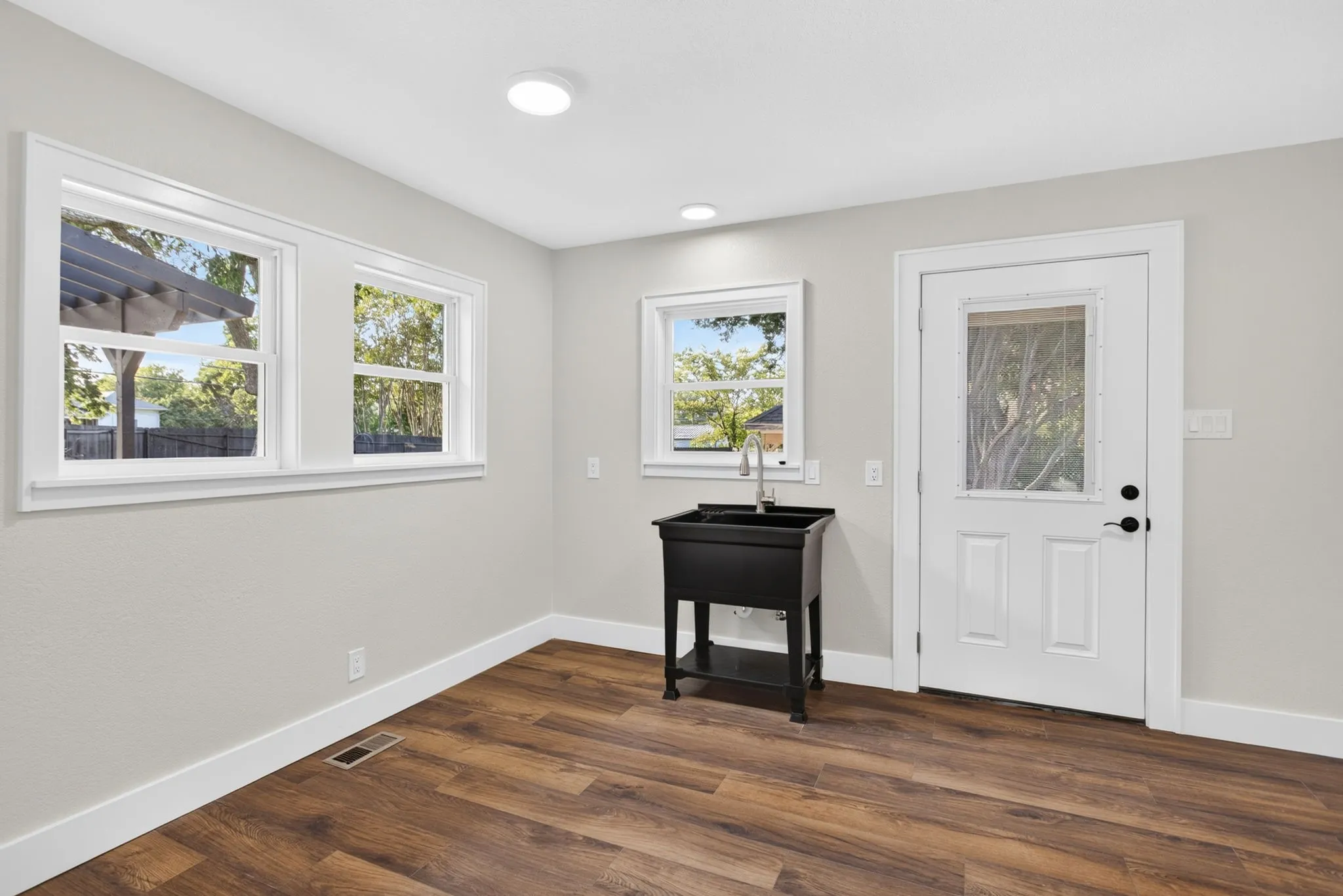 Giant laundry room with utility sink, hookups behind the photographer, and so much space. Plenty of room for mud lockers, drop zones, a folding counter, etc.