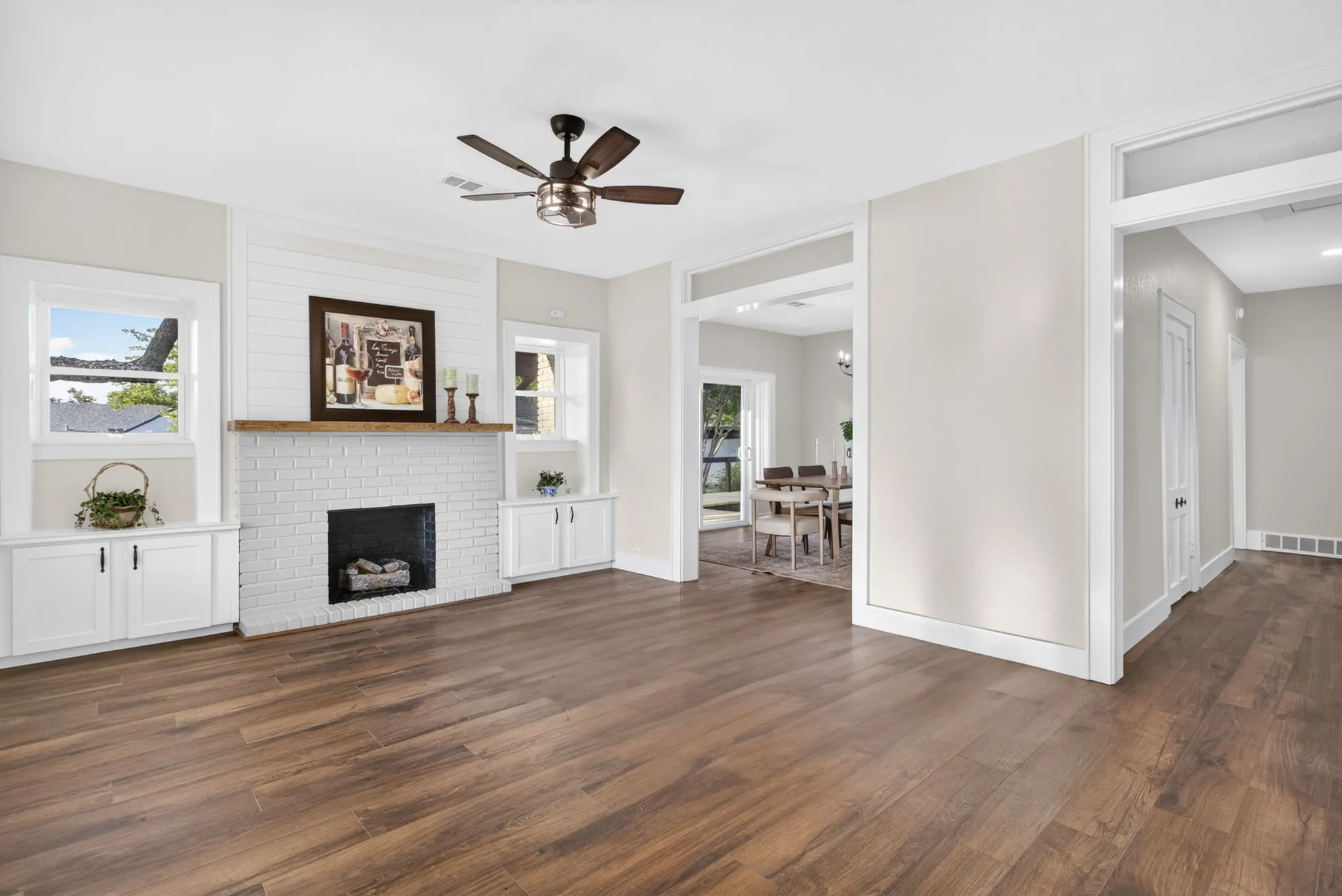 The home is 101 years old. Everything else is NEW! Formal front living. Reworked original built-ins flanking the fireplace; new LVP floors; new transoms, baseboards and casements in the same style as the original build.