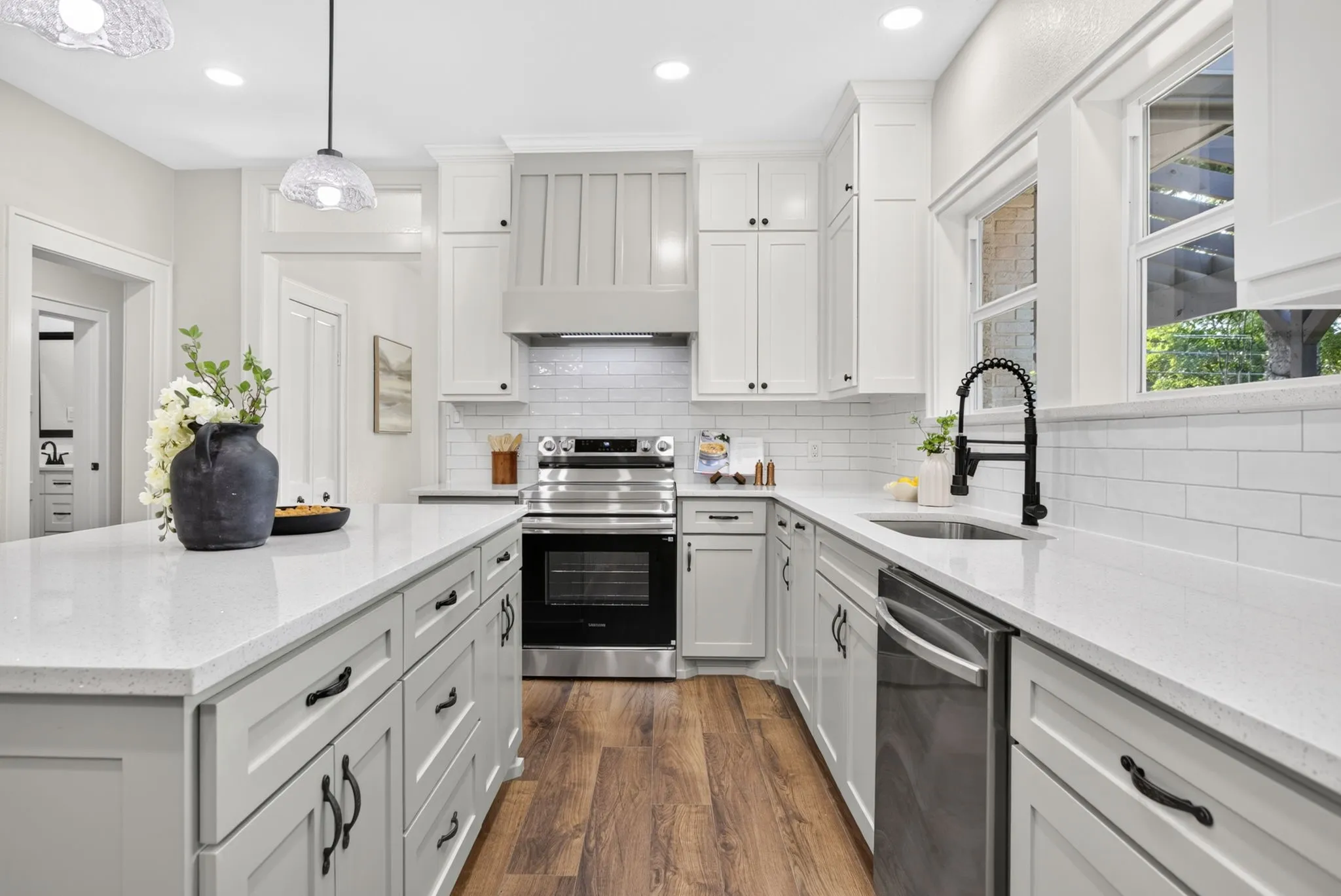 All new everything - from the shaker style soft close cabinetry, to the appliances, counters, backsplash, fixtures, hardware and lighting. Y'all peek that powder bath in the hallway.