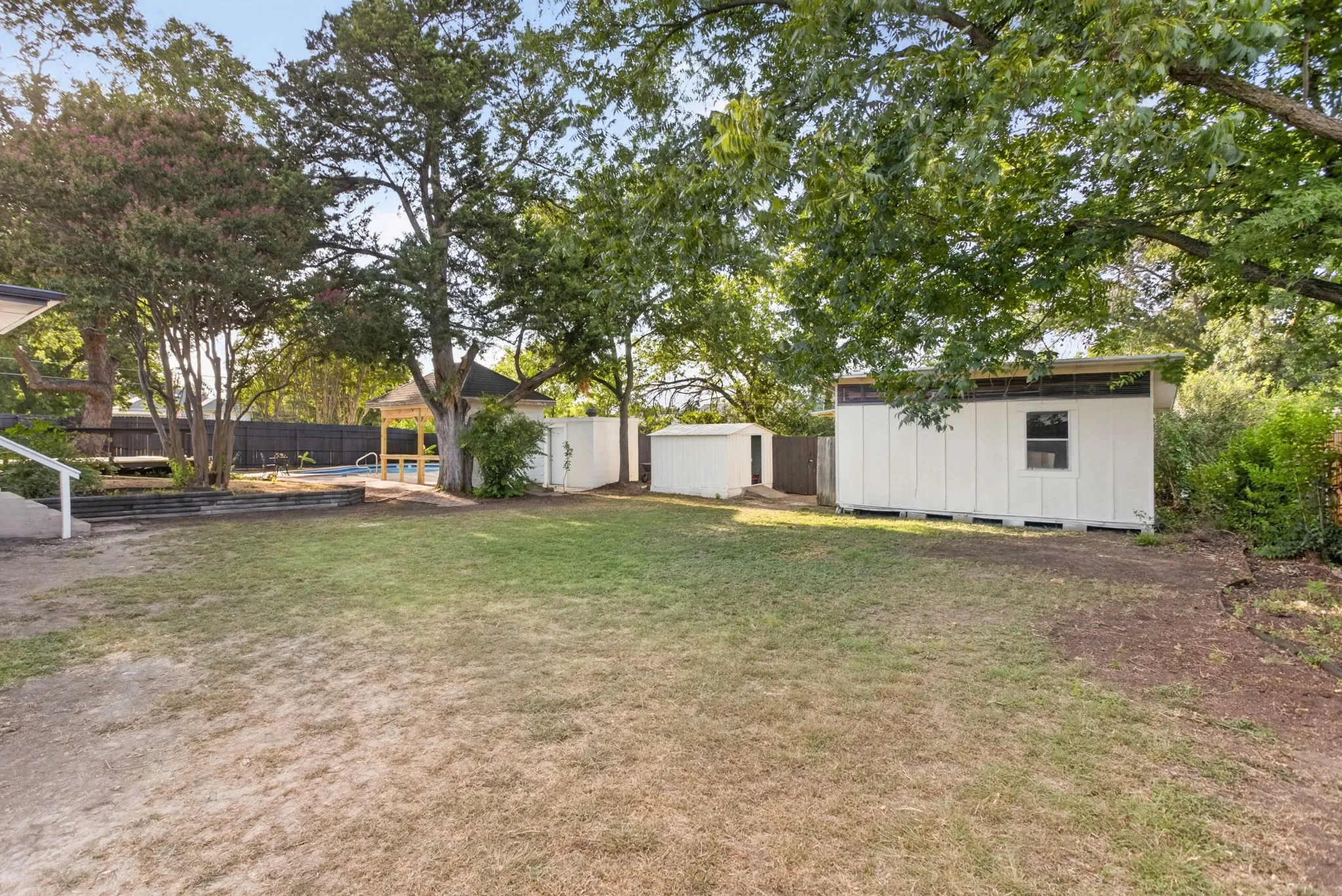 And there's MORE YARD. Complete with multiple storage buildings for convenience, storage, projects...
