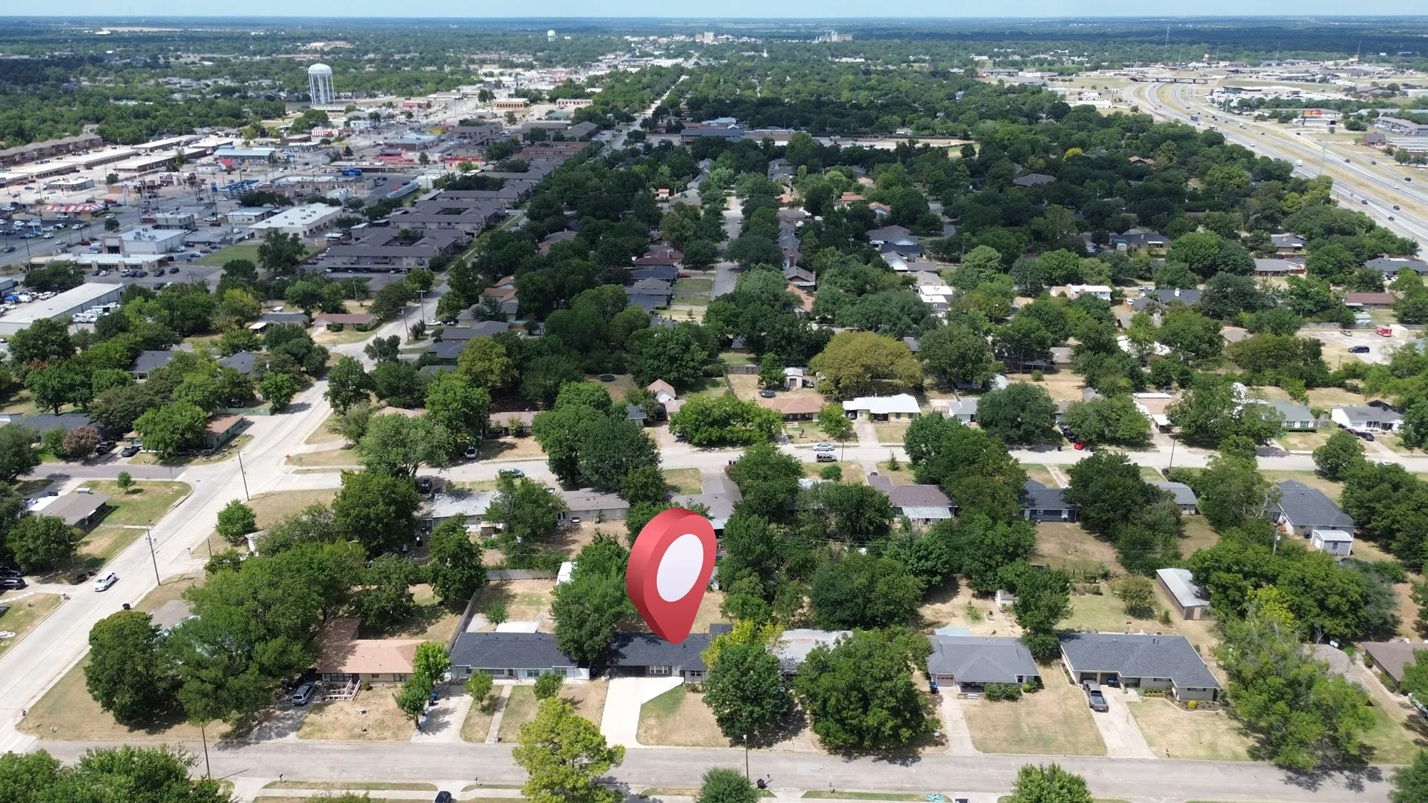 Aerial perspective of a residential neighborhood with mature trees