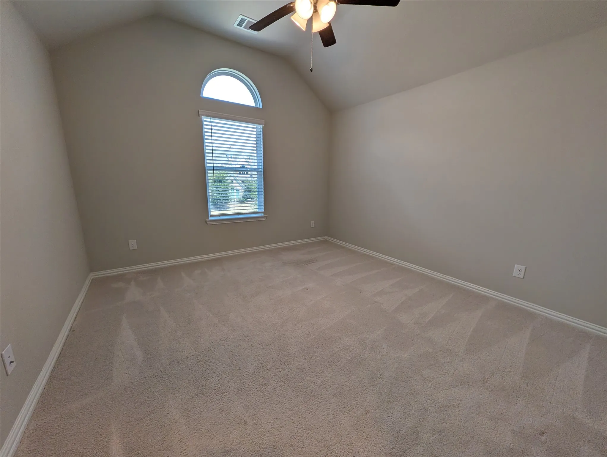 Vaulted ceiling featuring a ceiling fan with integrated lighting