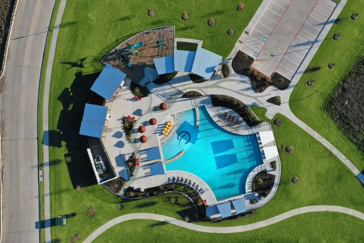 Community pool with integrated lounge areas and shade structures