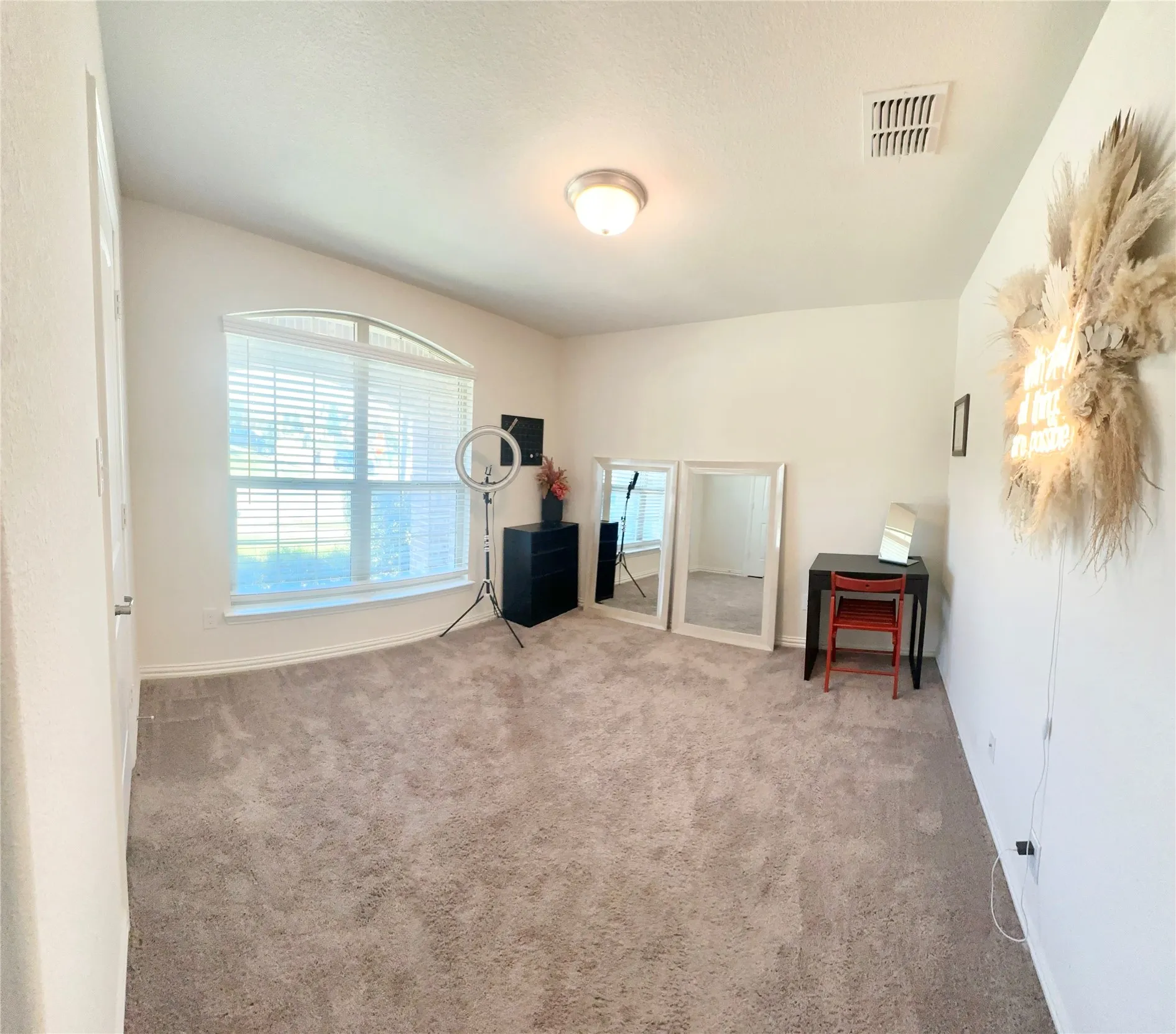 Bedroom 2-Spacious sleeping area with plush wall-to-wall carpeting, neutral-colored walls, a lone window dressed with blinds, and a standard overhead light.