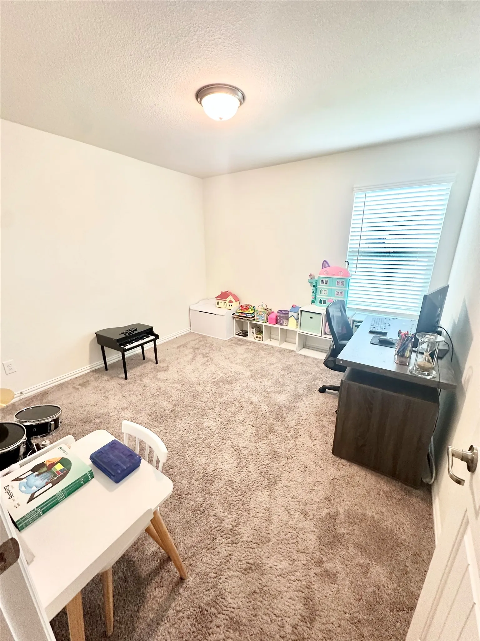 Bedroom 3-This photo features a spacious and well-lit bedroom, showcasing the neutral color palette, generous natural light, and ample room for furniture arrangement, highlighting it as a comfortable retreat within the home.