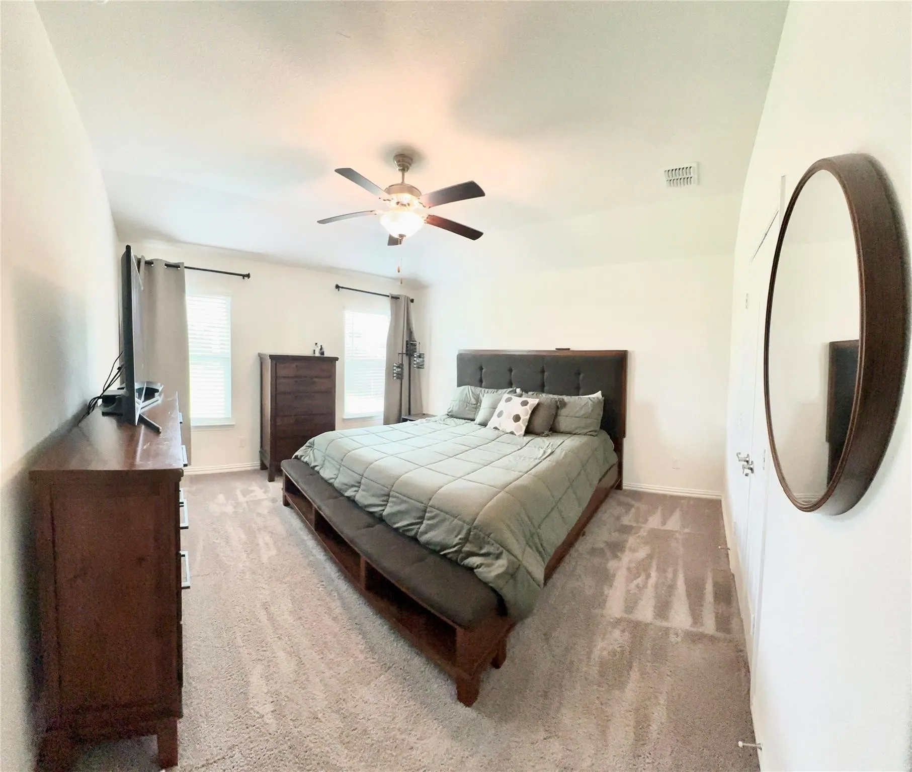 View of the owner's suite that's bright and spacious with comfortable carpeting and versatile neutral tones that complement any décor style.