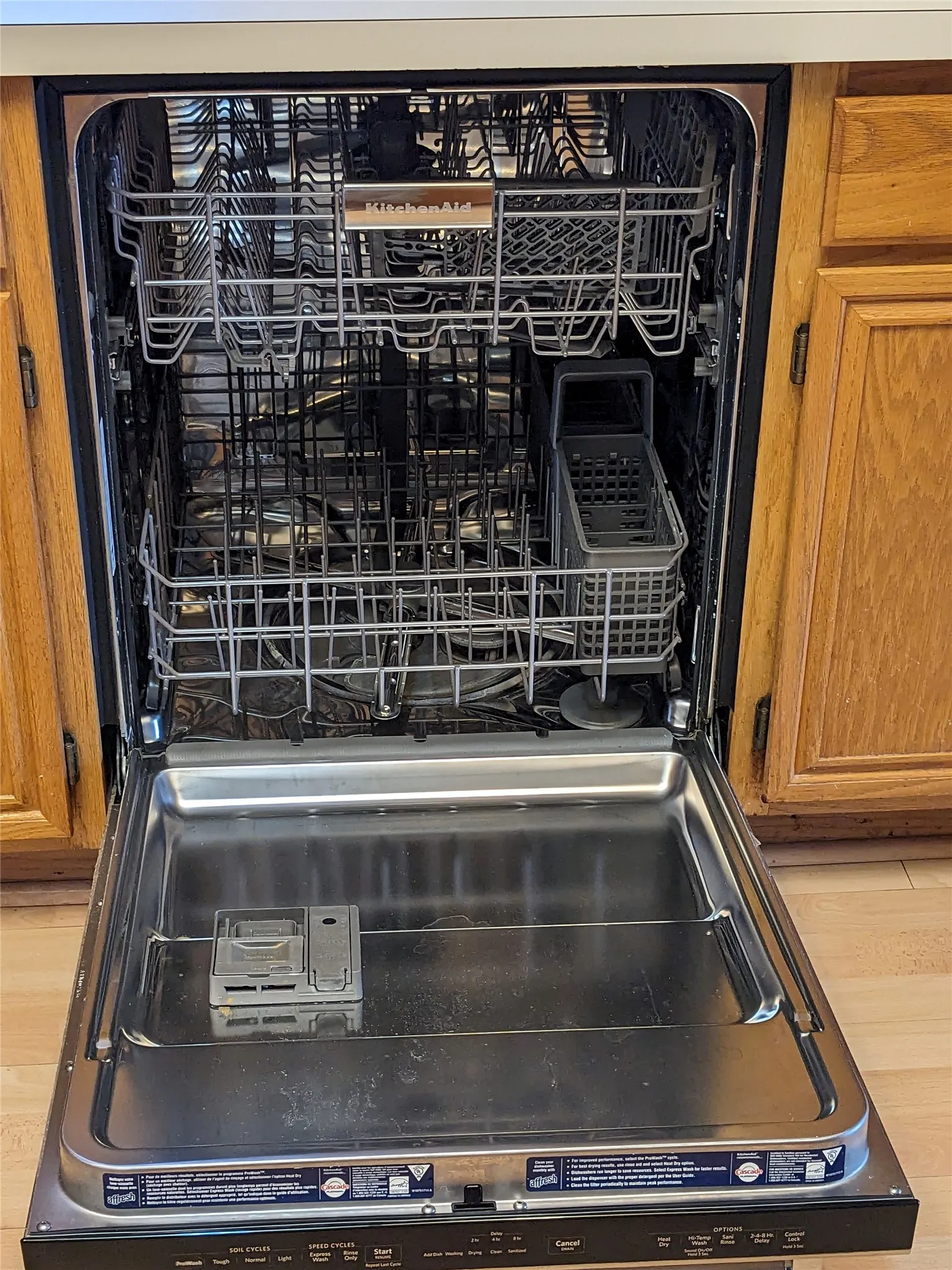 Stainless steel interior dishwasher with upper and lower racks and a utensil basket