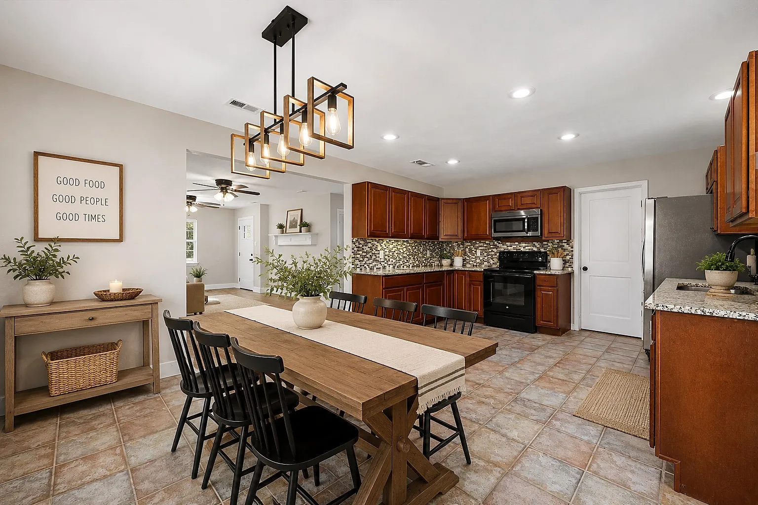 Open-concept layout featuring a kitchen with wood cabinetry, stainless steel appliances, and a tile backsplash
