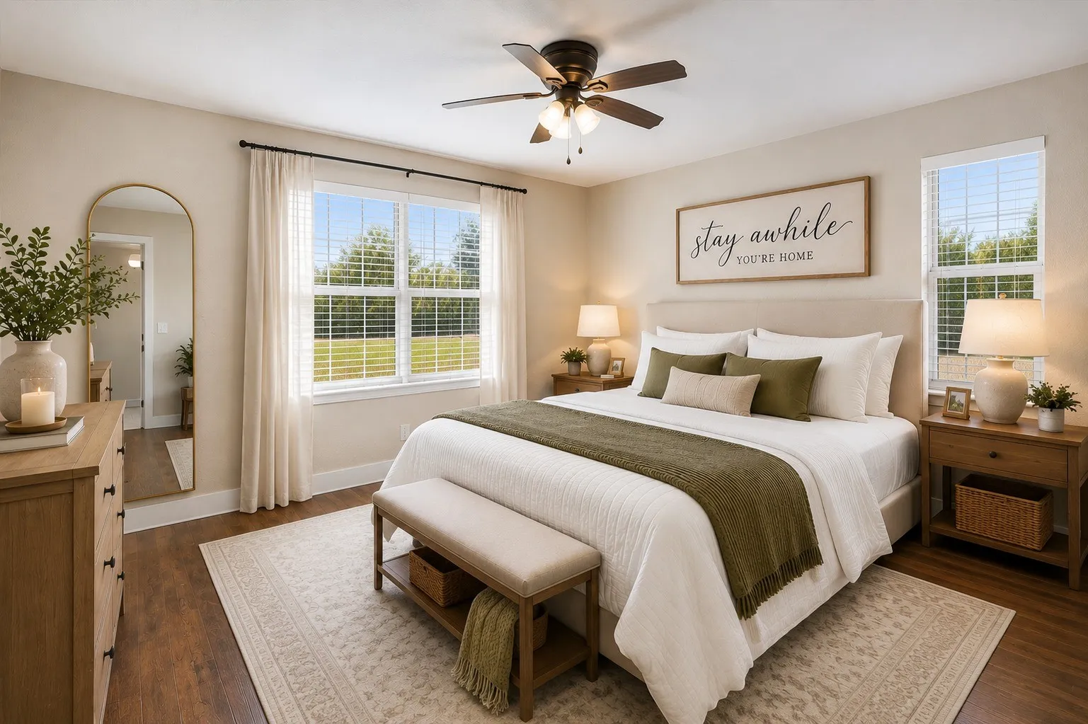 Wood-finish flooring, ceiling fan with integrated lighting, window with blinds, upholstered headboard, and built-in dresser