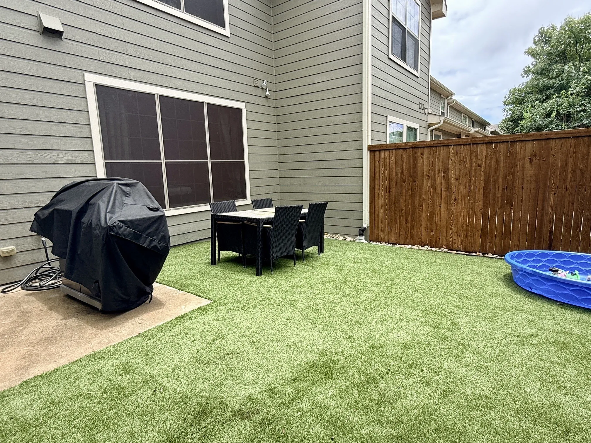 all turf grass, easy maintenance, wood privacy fence, patio and storage closet