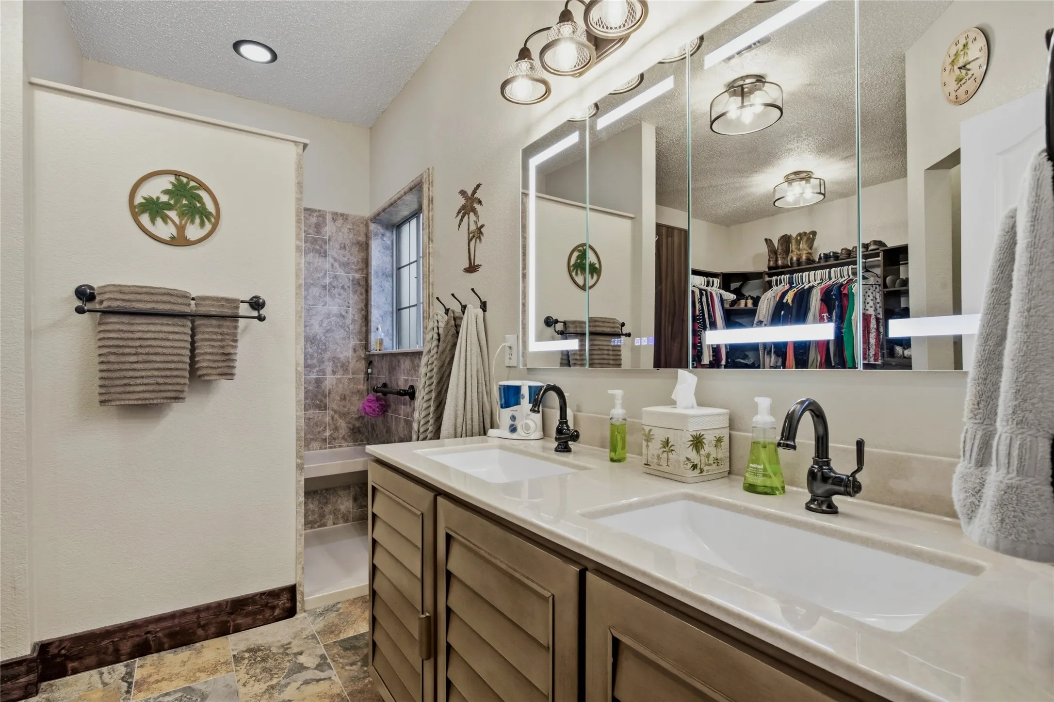 Updated primary suite bathroom has no interior doors - beautiful and smooth transitions in your suite.