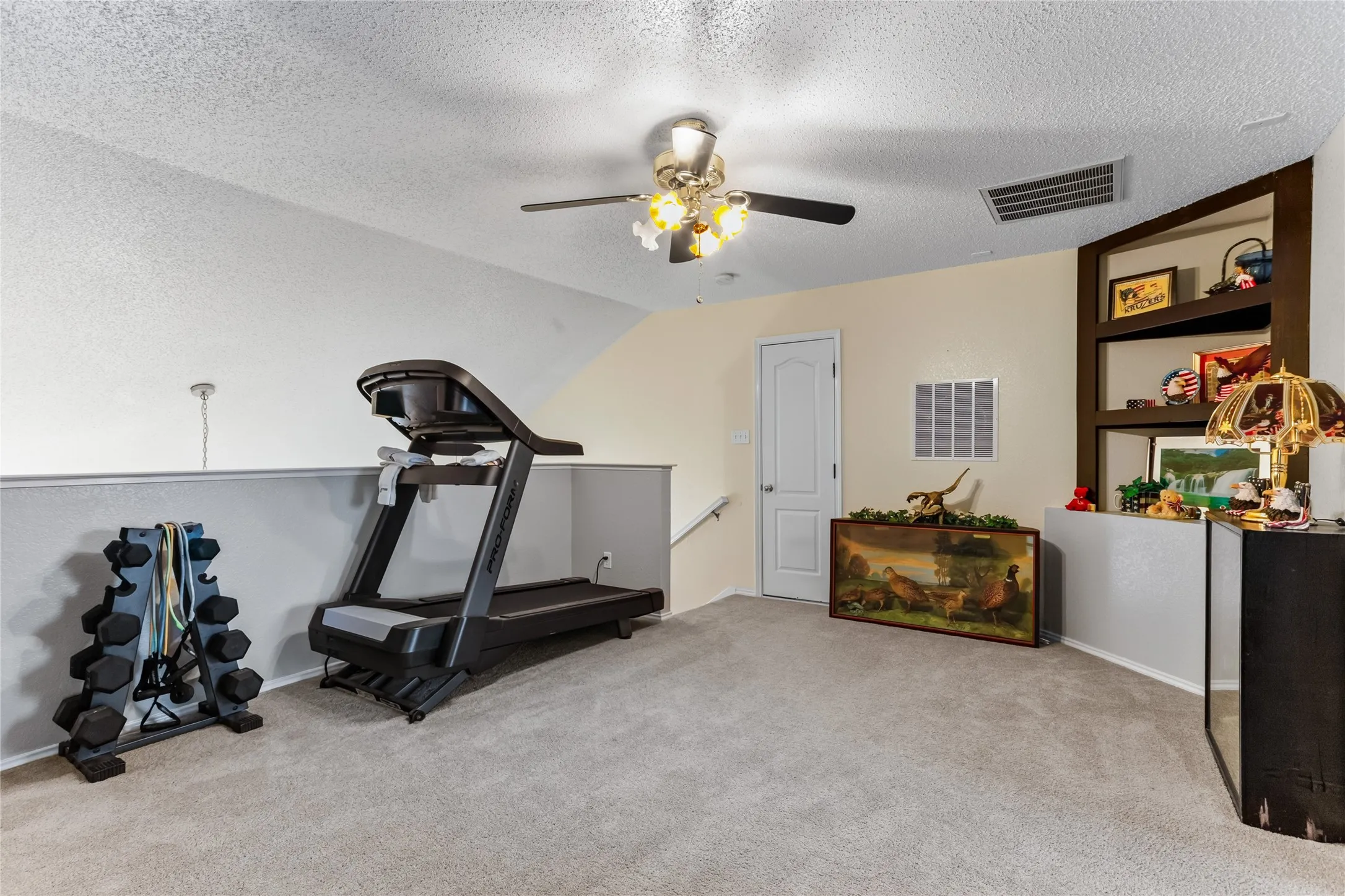 Top of the stairs, this versatile loft space will serve many needs. Plenty of storage, too.